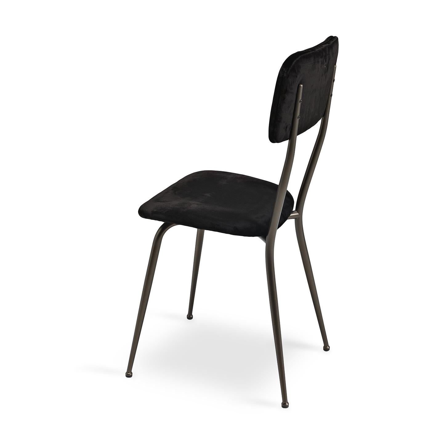 Dark tones and sleek lines define this elegant chair, updating a classic silhouette with a glamorous twist. Boasting a clean metal frame with a brushed bronze finish, this piece is defined by luxurious black velvet upholstery. Offering a padded seat