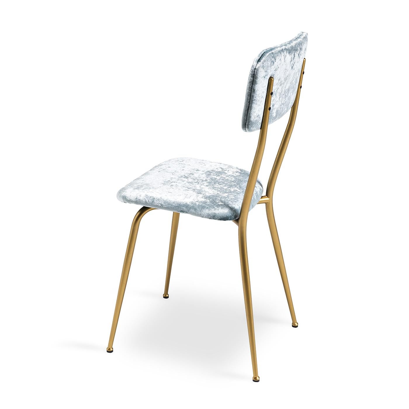 Add a sophisticated touch to your modern living space with the Miss Ava 9 Chair. Defined by a sleek, understated Silhouette, its metal frame boasts a brushed brass finish. Light blue velvet upholstery creates a calming Ambience, whilst blending