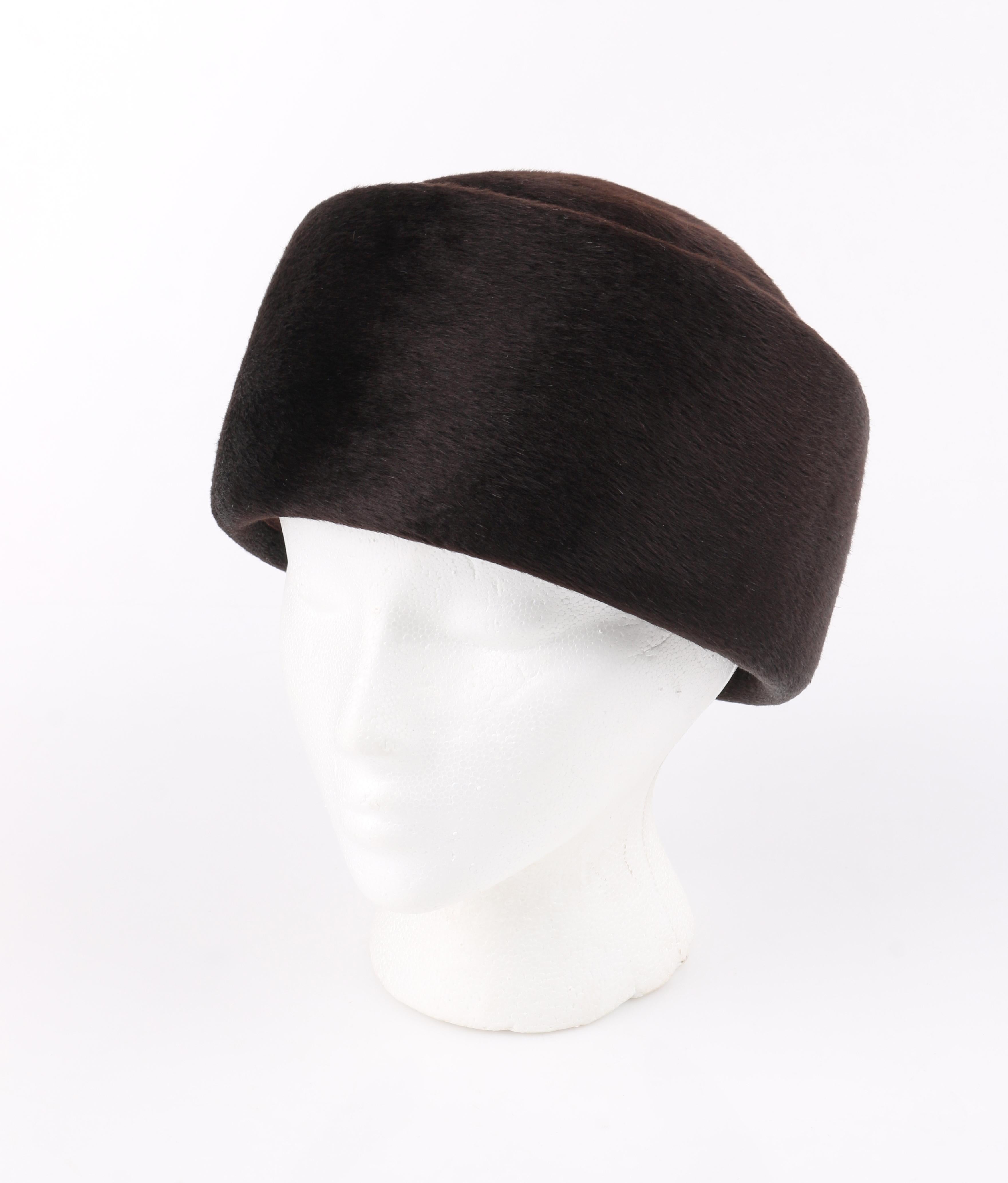 Miss Dior CHRISTIAN DIOR c.1960’s Marc Bohan Dark Brown Felted Fur Pillbox Hat 
 
Circa: 1960’s
Label(s): Miss Dior By Christian Dior
Designer: Marc Bohan
Style: Hat
Color(s): Brown
Lined: Yes 
Unmarked Fabric Content: Felted Fur (exterior);
