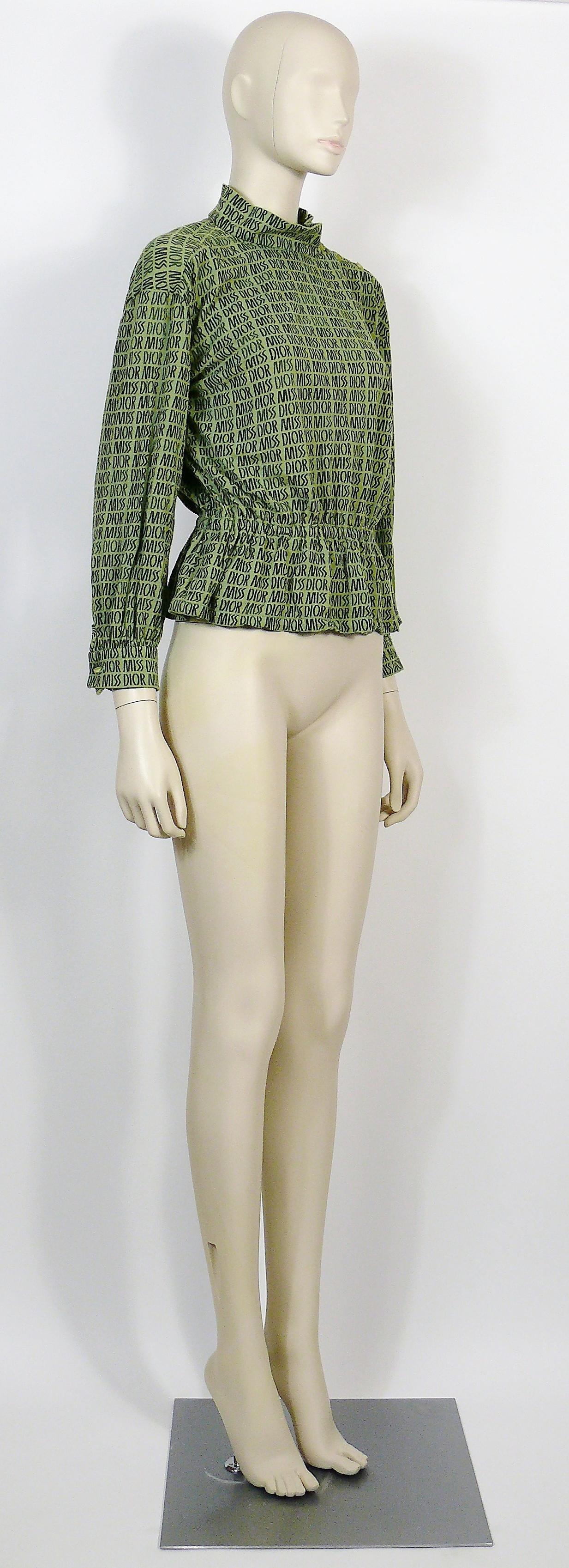 MISS DIOR vintage rare green blouse featuring MISS DIOR logos all over.

This blouse features :
- Sretchy fabric (unidentified composition).
- Mock neck with side buttoning.
- Button closure on each cuff.
- Peplum elastic waist.
- Long