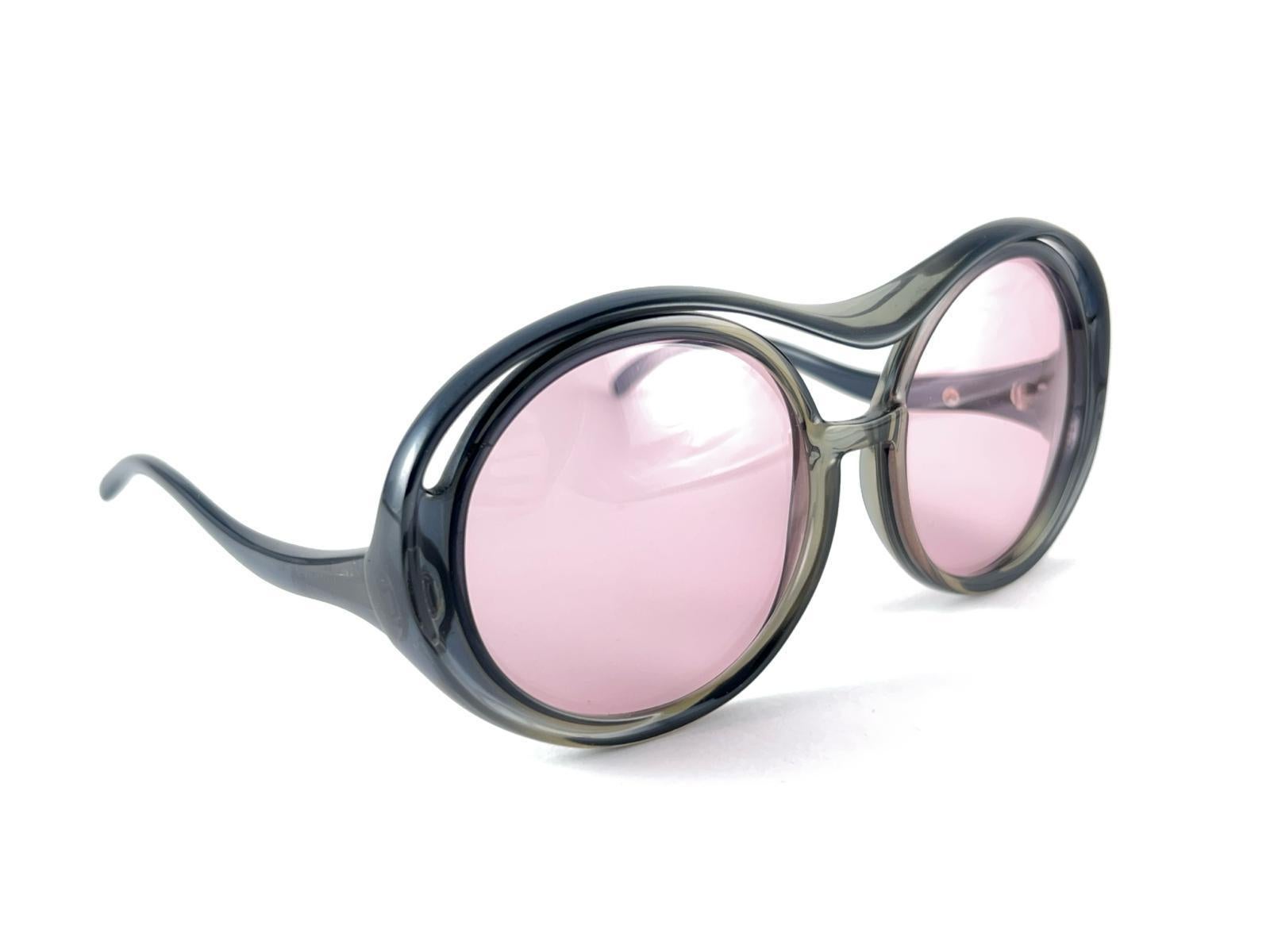 Mint Vintage Miss Dior OVERSIZED frame with light Pink lenses. 
Produced and design in 1970's.  
A collector’s piece! . It has some wear due to 40 years of storage.

 Made in Austria.  

Front                                      16 Cms
Lens Height 