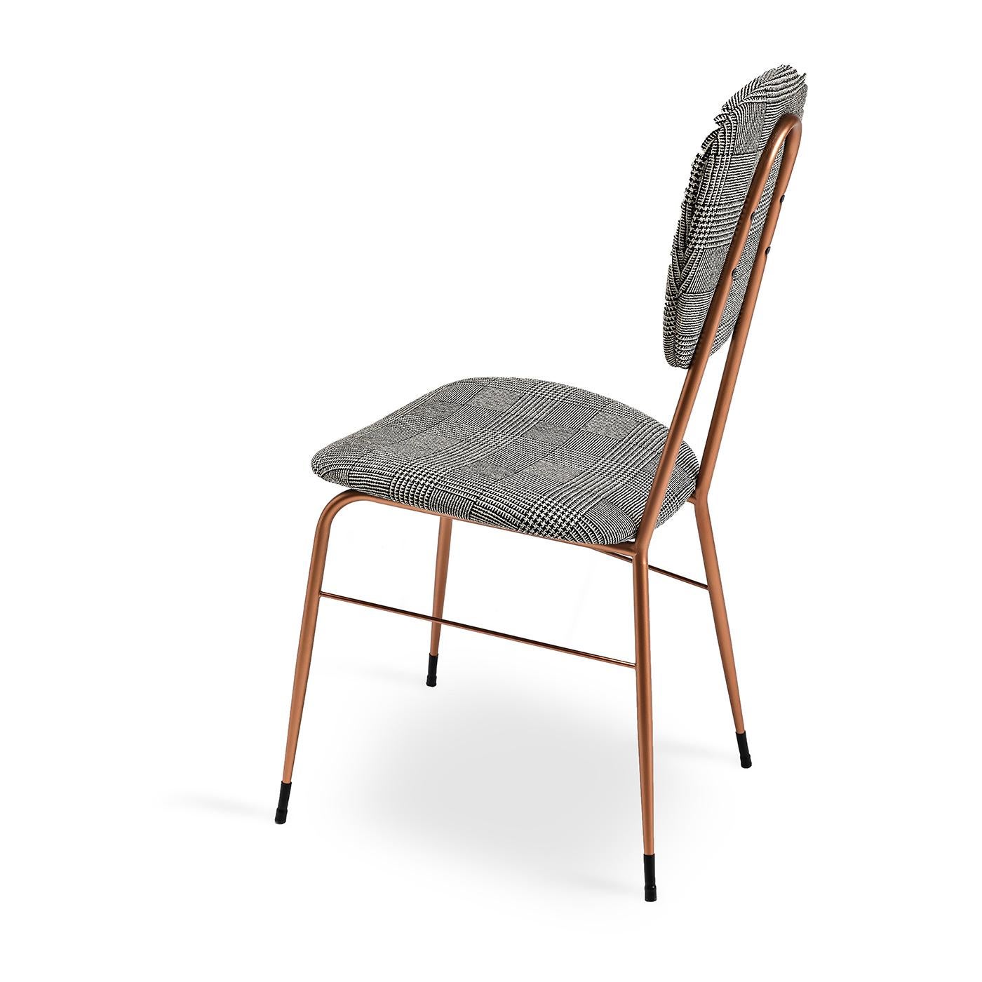 This cute dining chair is comfy and pretty to look at, with a back and seat that are structured thanks to polyurethane and curved wood inserts and upholstered in a non-removable, gray Glen plaid fabric for a homey look. The chair has a metal frame