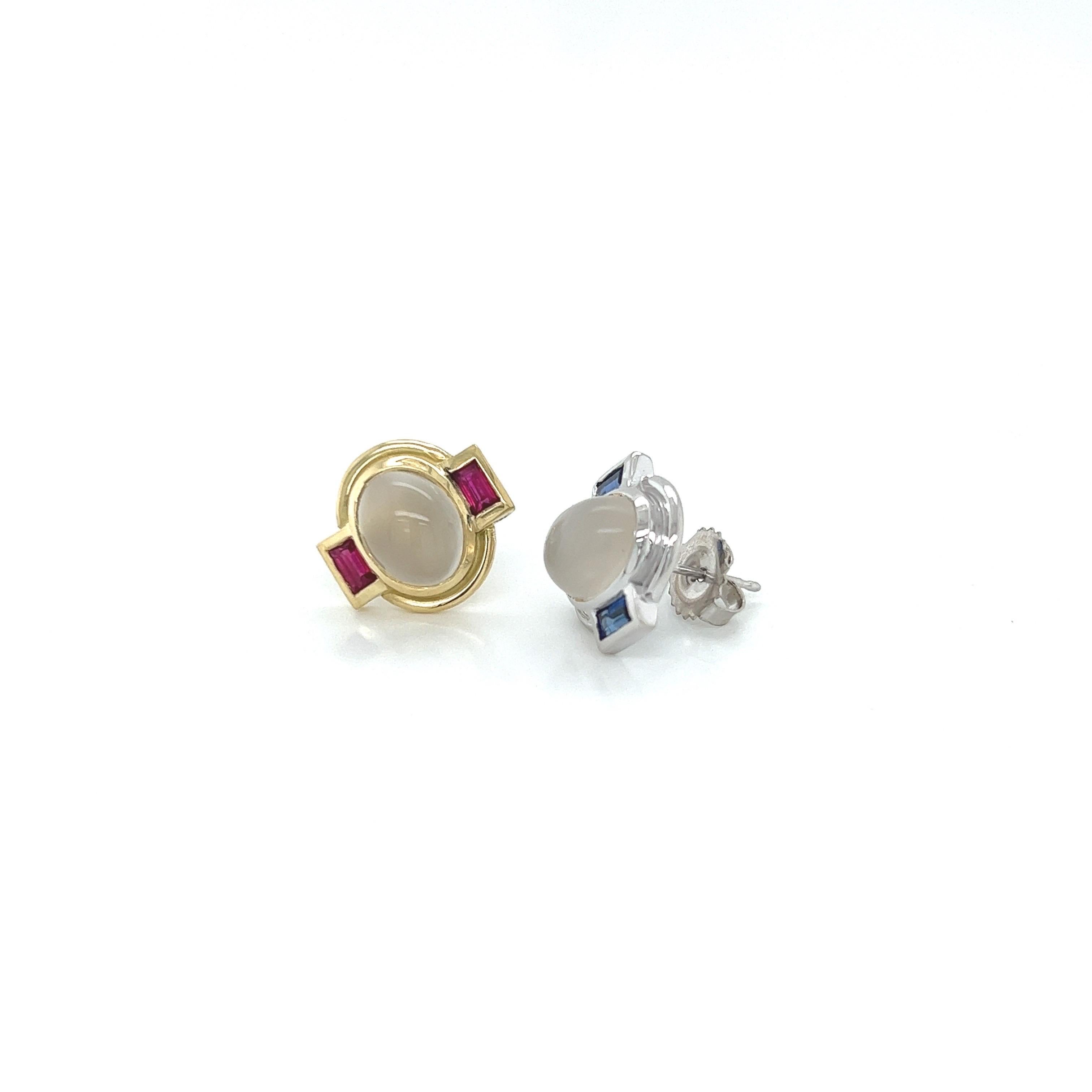 A pair of miss match stud earrings.
One earring is made in 18k yellow gold with cabochon moonstone center and ruby baguettes on the sides. The second earring is made in 18k white gold with moonstone cabochon in the center and sapphire baguettes on