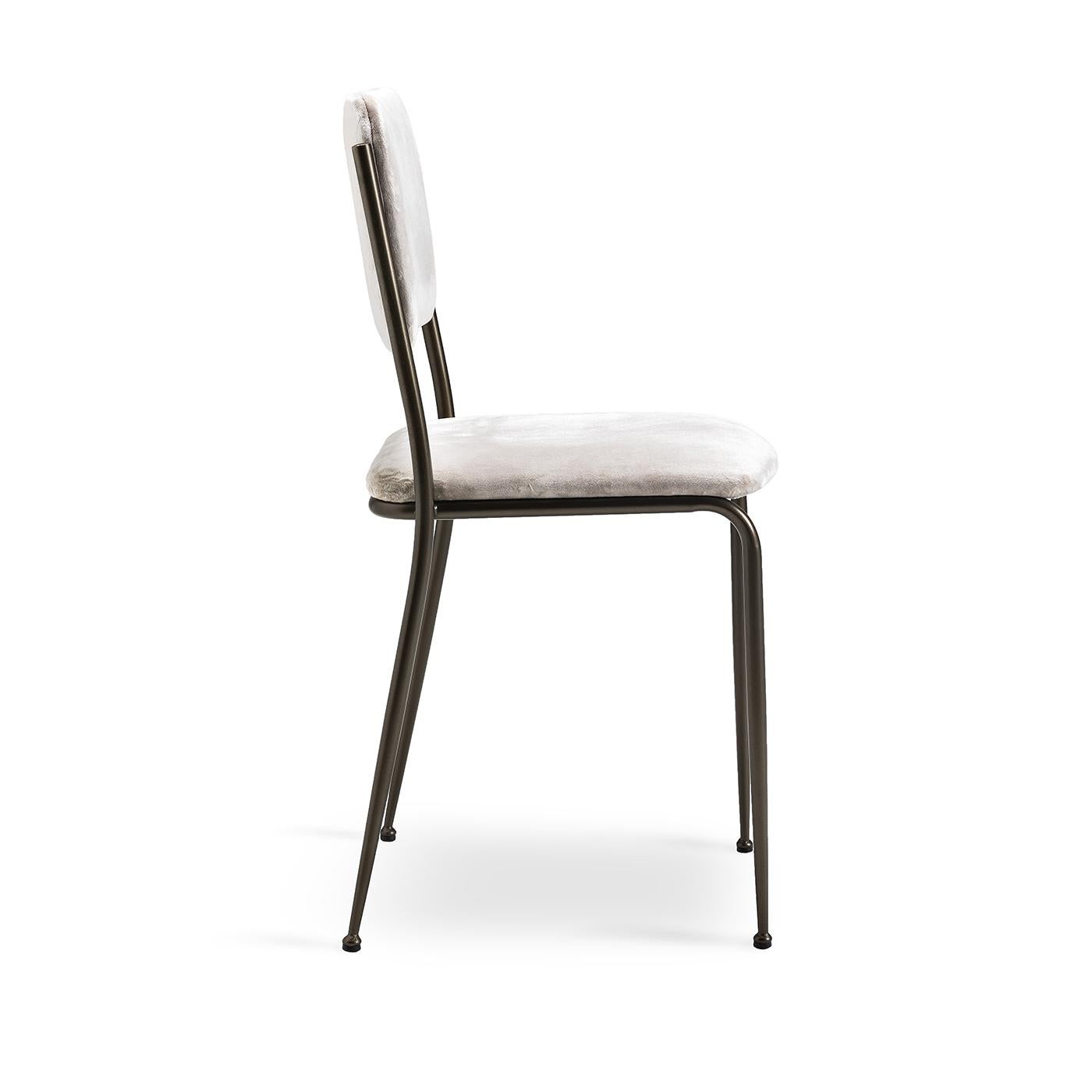 This lovely little dining chair with a bit of vintage spark has a simple metal frame and legs that are painted in a brushed matte bronze finish. The seat and back are both upholstered in white velvet, and comfort is guaranteed with seat and back