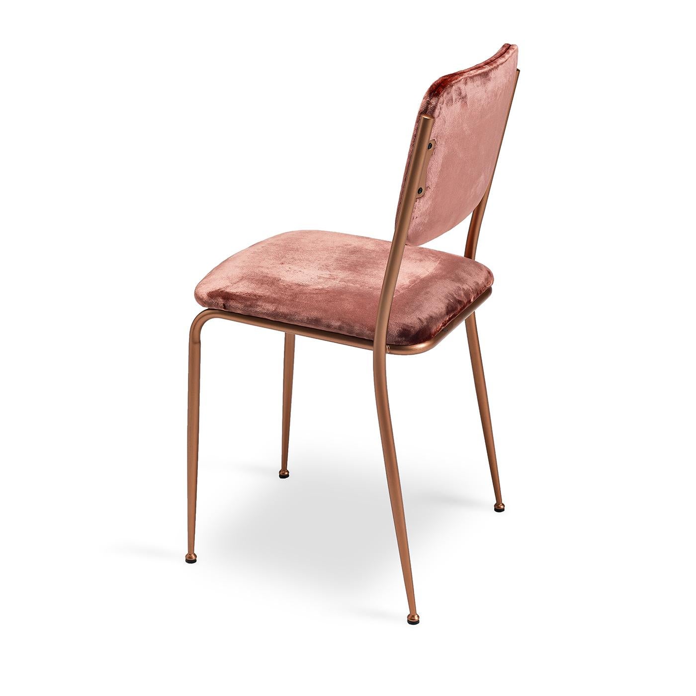 Use this cute little vintage-inspired dining chair to spice up any dining room. The seat and back are both upholstered in a blush-colored velvet, while the back and seat are structured with polyurethane and curved wood inserts for comfort. The