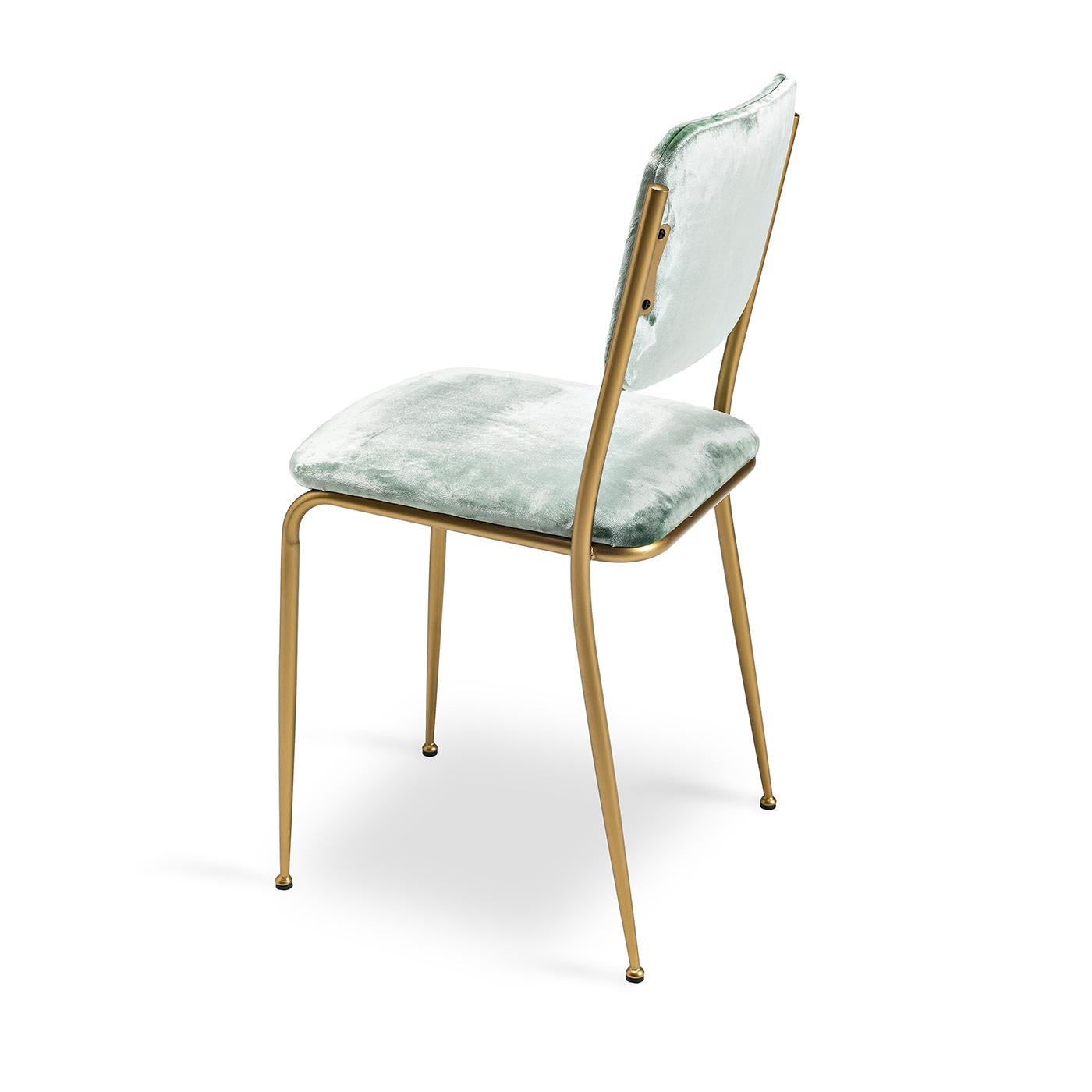 This cute vintage-inspired dining chair will add a bit of charm to any dining room. This chair’s seat and back are upholstered in light green velvet, while the back and seat are structured with polyurethane and curved wood inserts. The simple metal