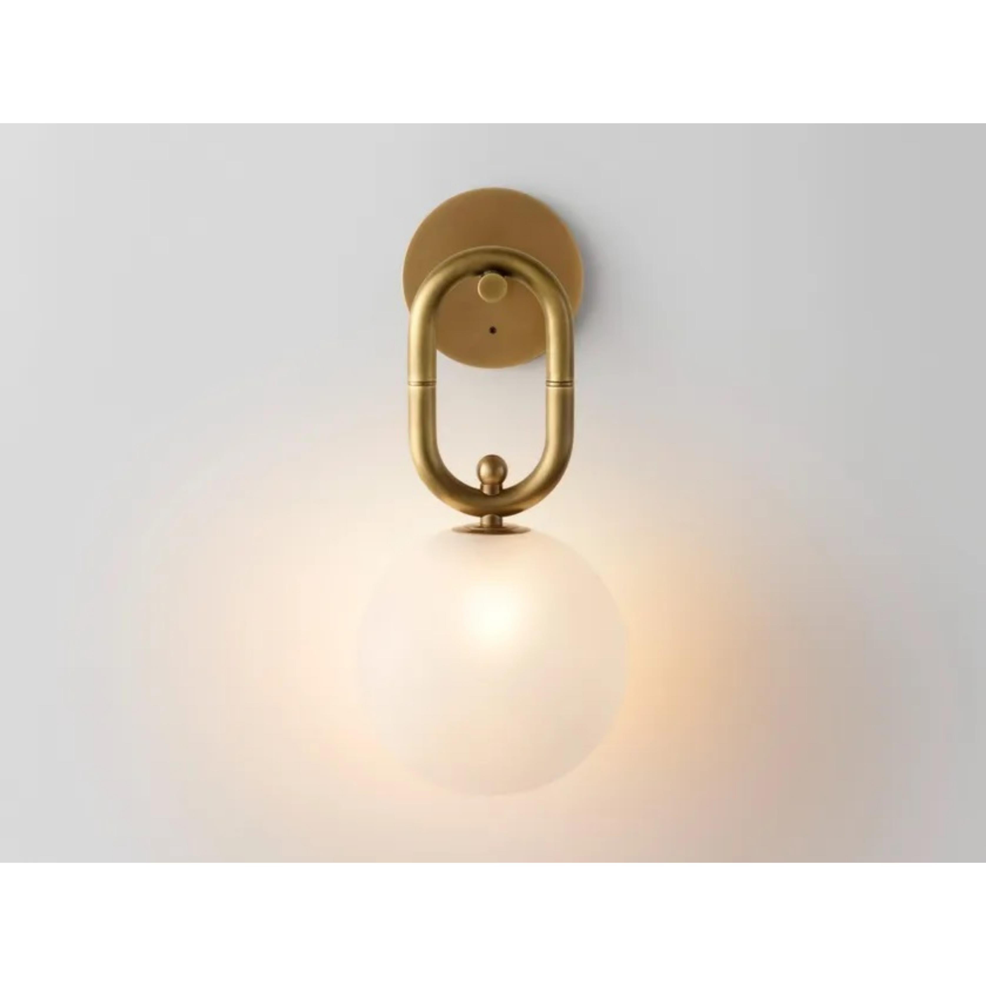 Missing link wall sconce by Volker Haug
Dimensions: Diameter 15 x height 34 cm 
Material: Brass. 
Finish: Polished,aged, brushed, bronzed, blackened, or plated
Lamp: 240V G9 LED or 12V G4 LED
Glass Shell: ø 150 mm opal or frosted
Weight: