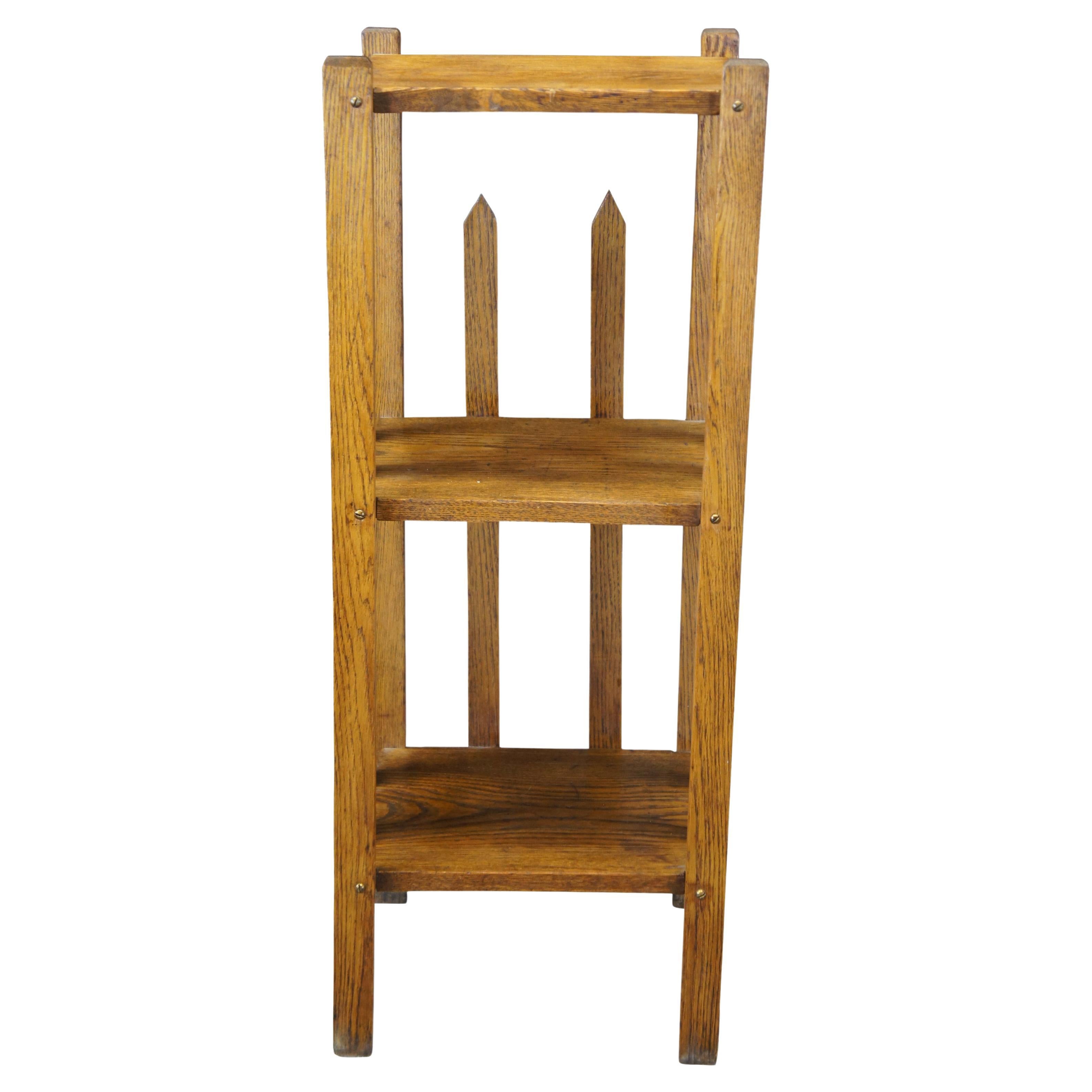 Mid 20th century mission oak 3 tier stand or bookshelf. Features an open design enclosed by spear shaped fence pickets.
     