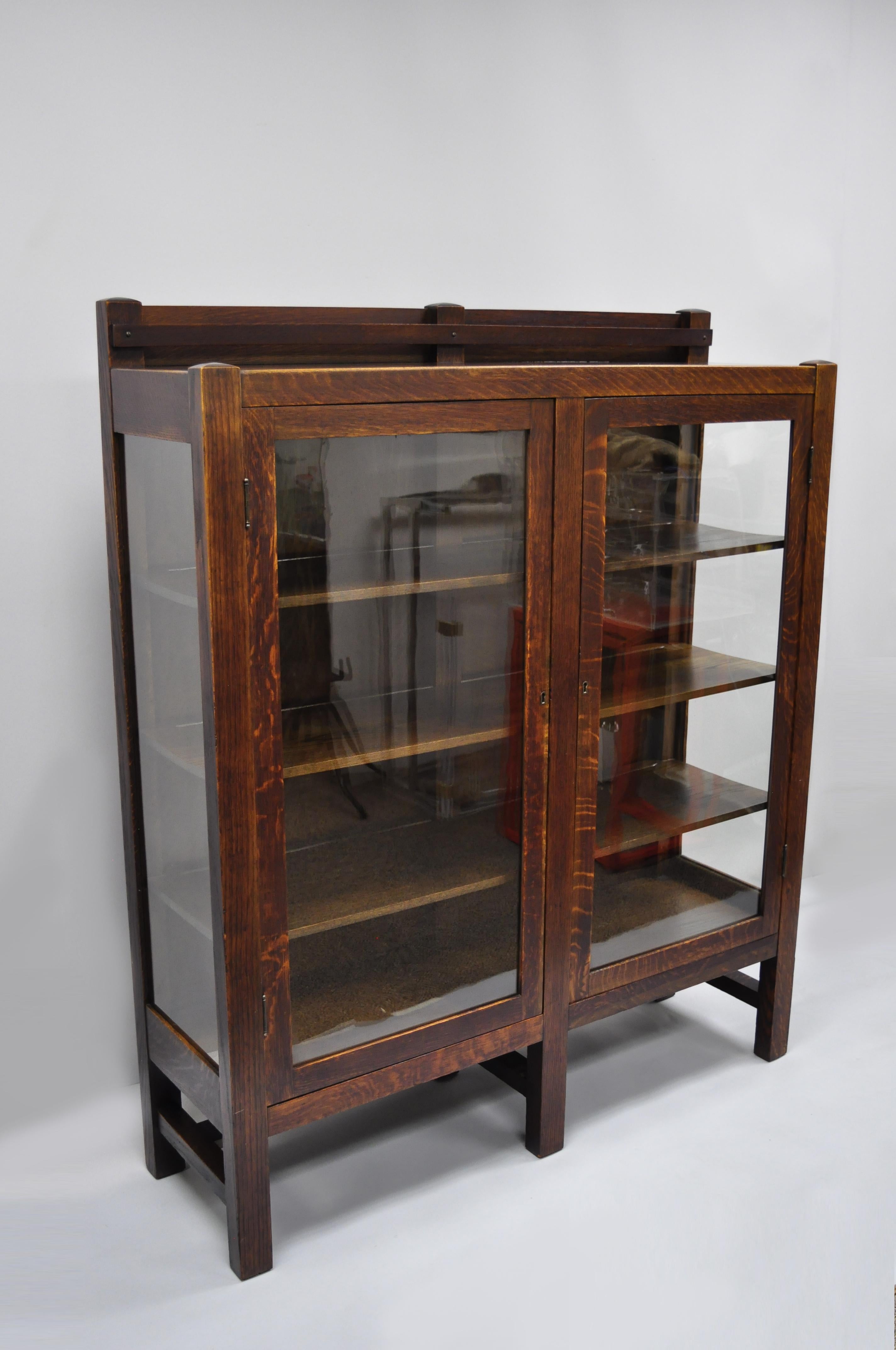 Mission Arts & Crafts Stickley era glass double door China cabinet bookcase. Item features 6 legs, stretcher base, 2 glass doors, glass sides, solid wood construction, beautiful wood grain, working lock and key, 3 wooden shelves, quality American