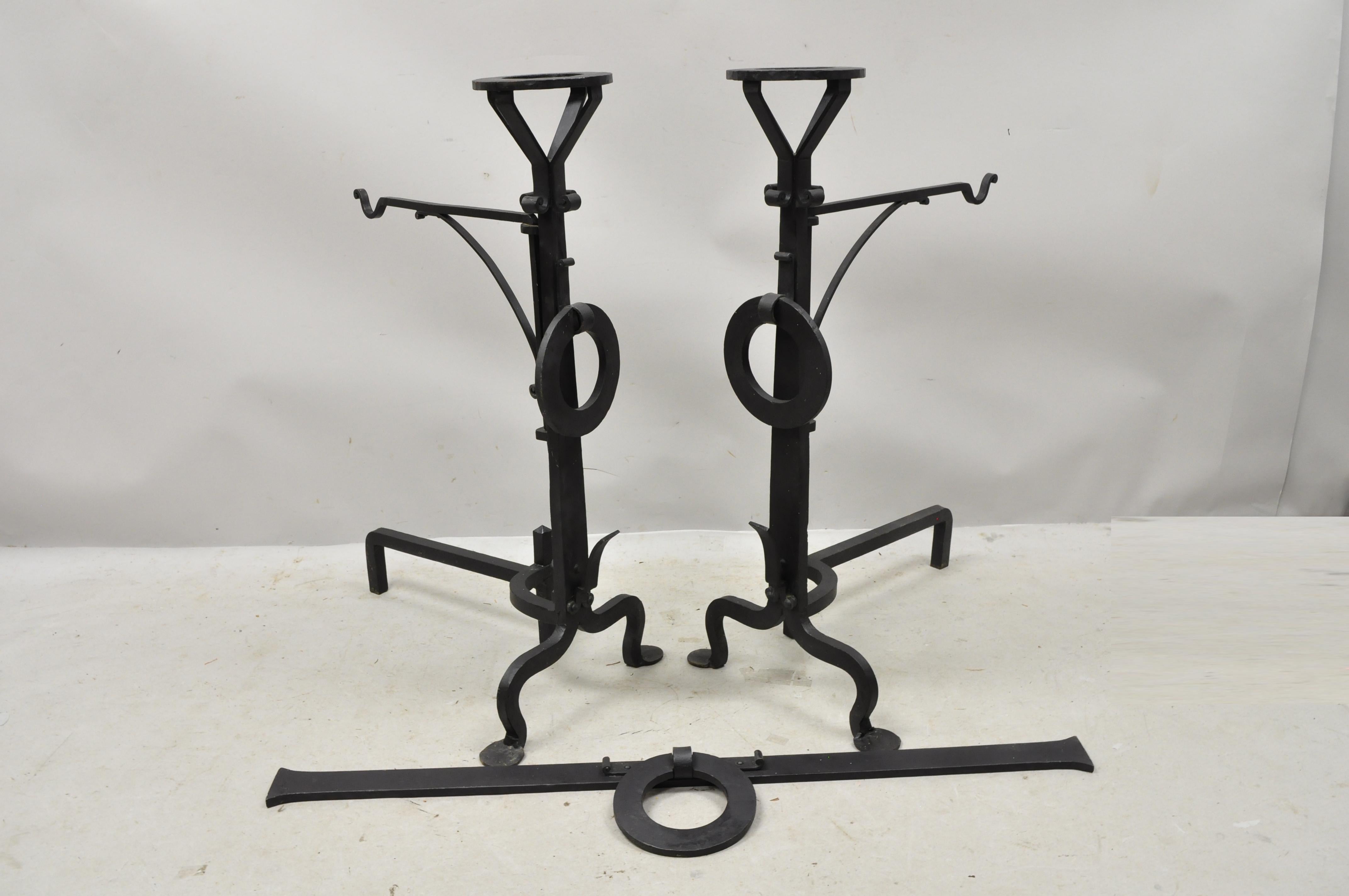 Antique Mission Arts & Crafts wrought cast iron long fireplace andirons and base - 3pc set. Item features 2 swing arms for pots, large iron drop rings, hand forged details, removable bar with ring, wrought iron construction, very nice antique item,