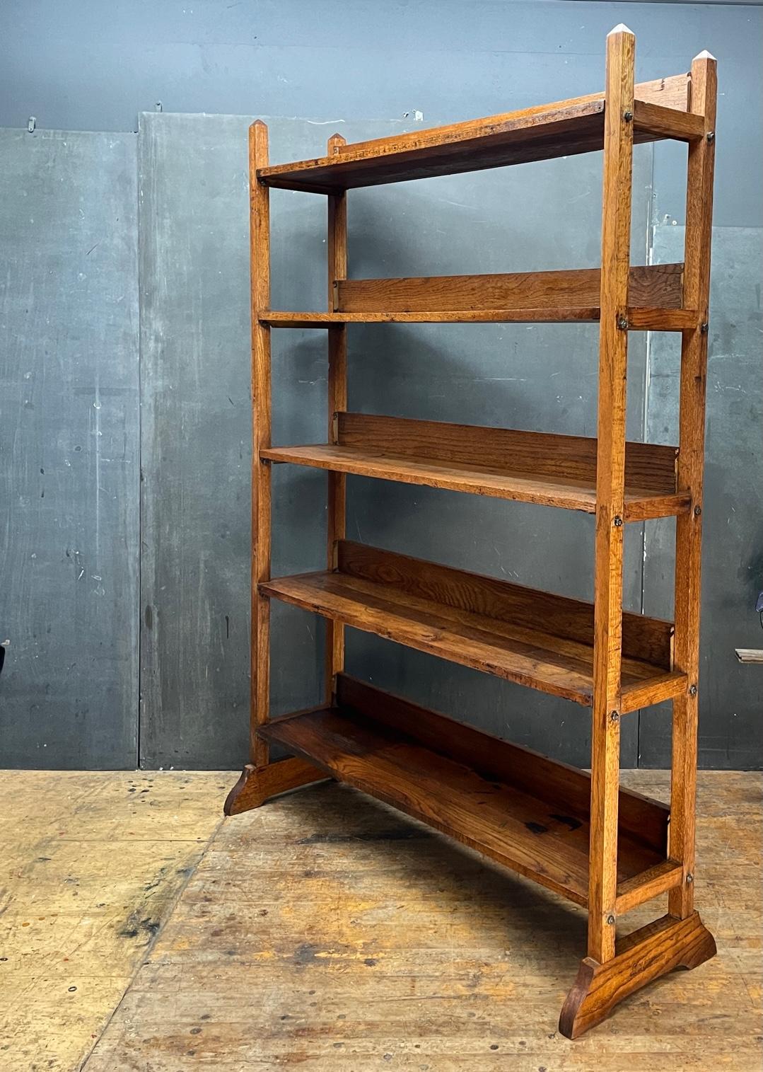 Beautifully Patinated piece of Stickley style mission era furniture. A large and wide modular solid Oak Bookcase or General Store Display. Sturdy and Usable as designed. Does disassemble. It is all constructed of solid oak with metal joint