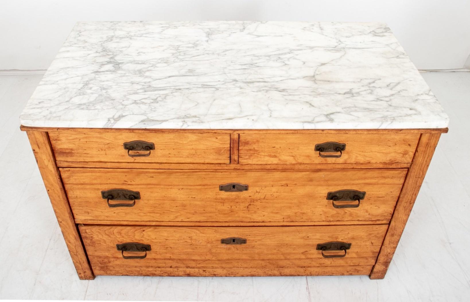 Arts and Crafts / Mission style hardwood dresser with two short drawers above two long drawers, with Art Deco manner brass pulls and Carrara marble top.

Dimensions: 27.25