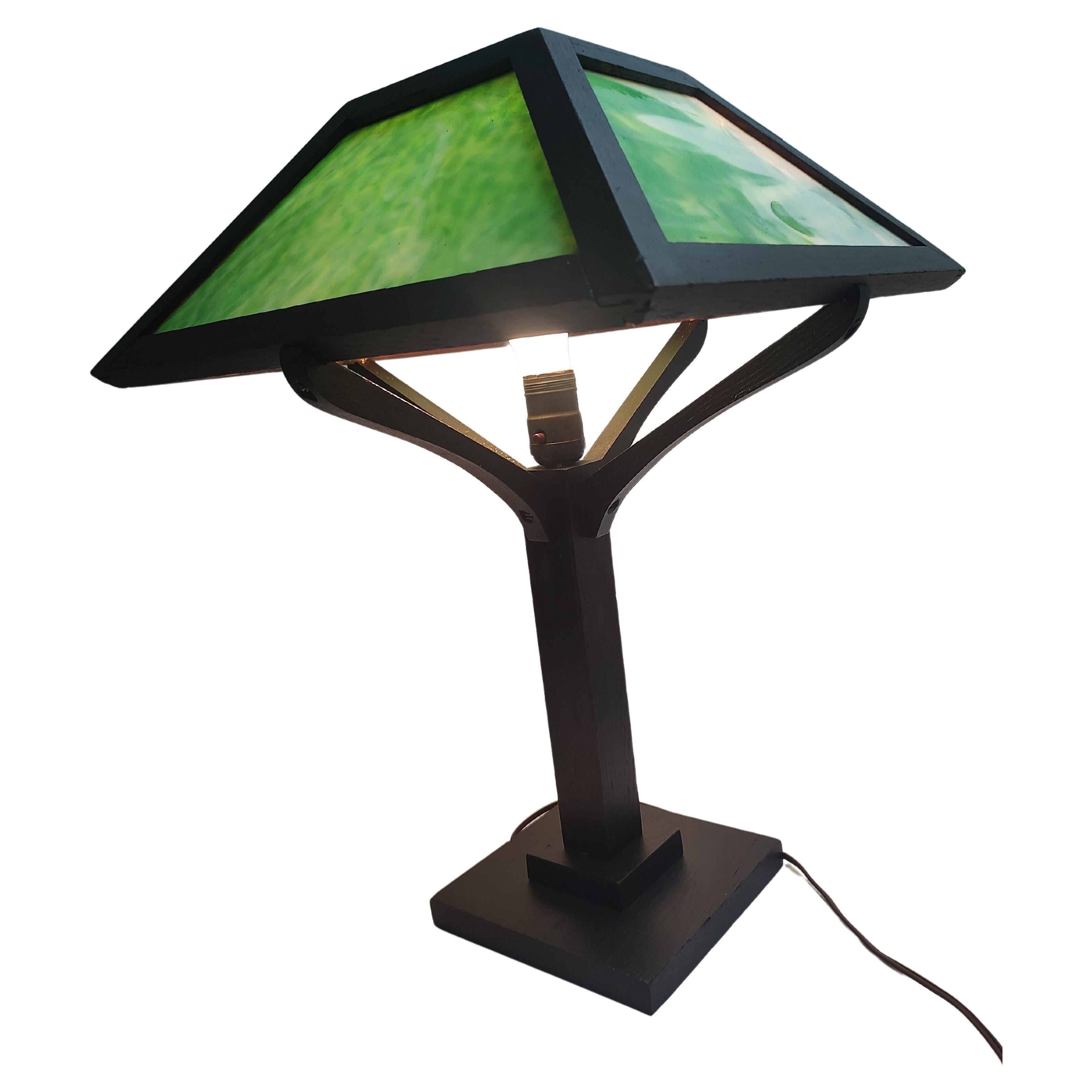 Beautiful green Slag Glass panels give off a charming and warm glow when lit. C1912 lamp is in excellent antique condition and has recently been refinished with a dark mission Oak stain. Wiring is sound. 
See my other mission lamps and furniture in