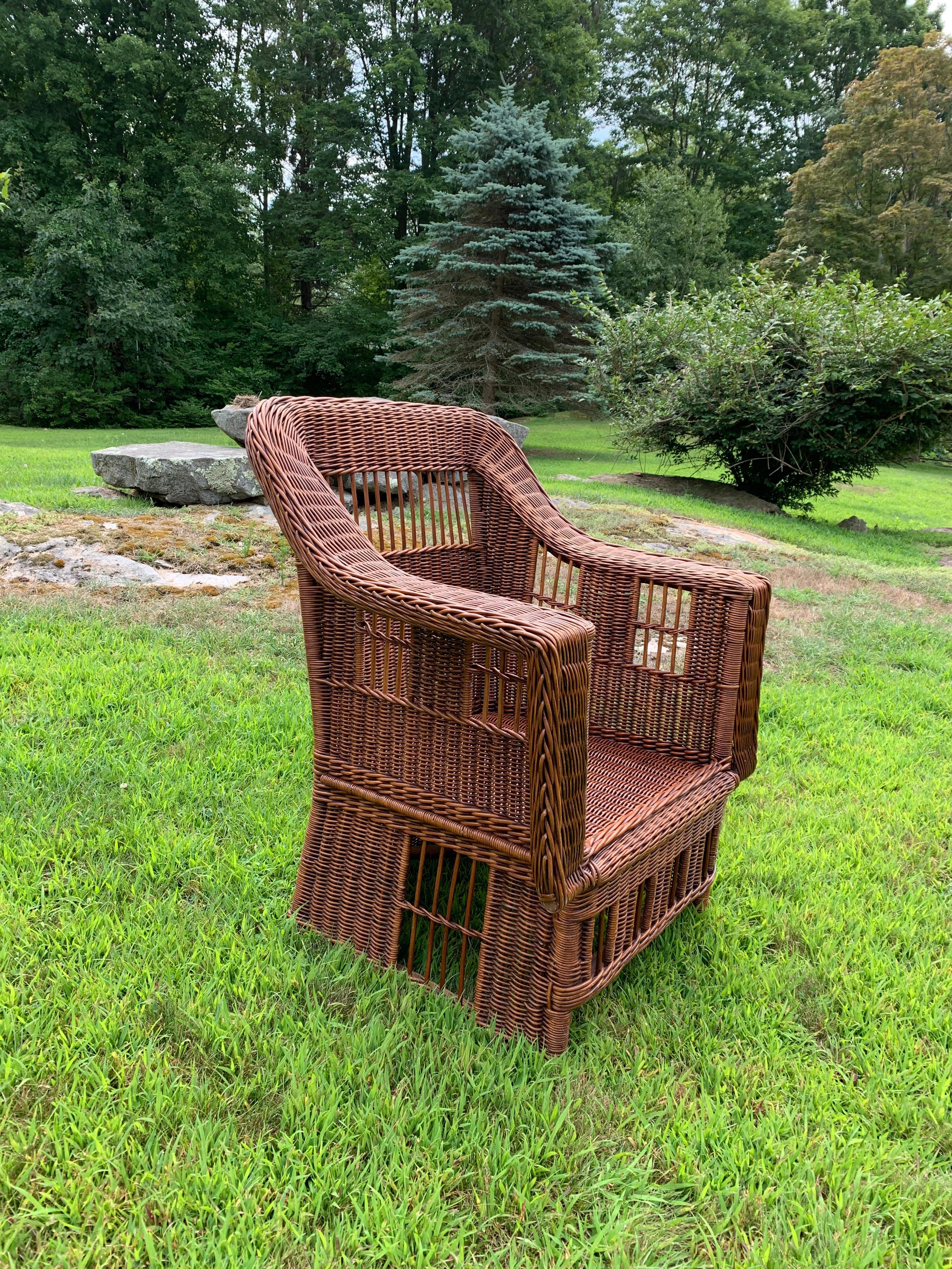 Wicker armchair in a natural stained finish in a Mission style.