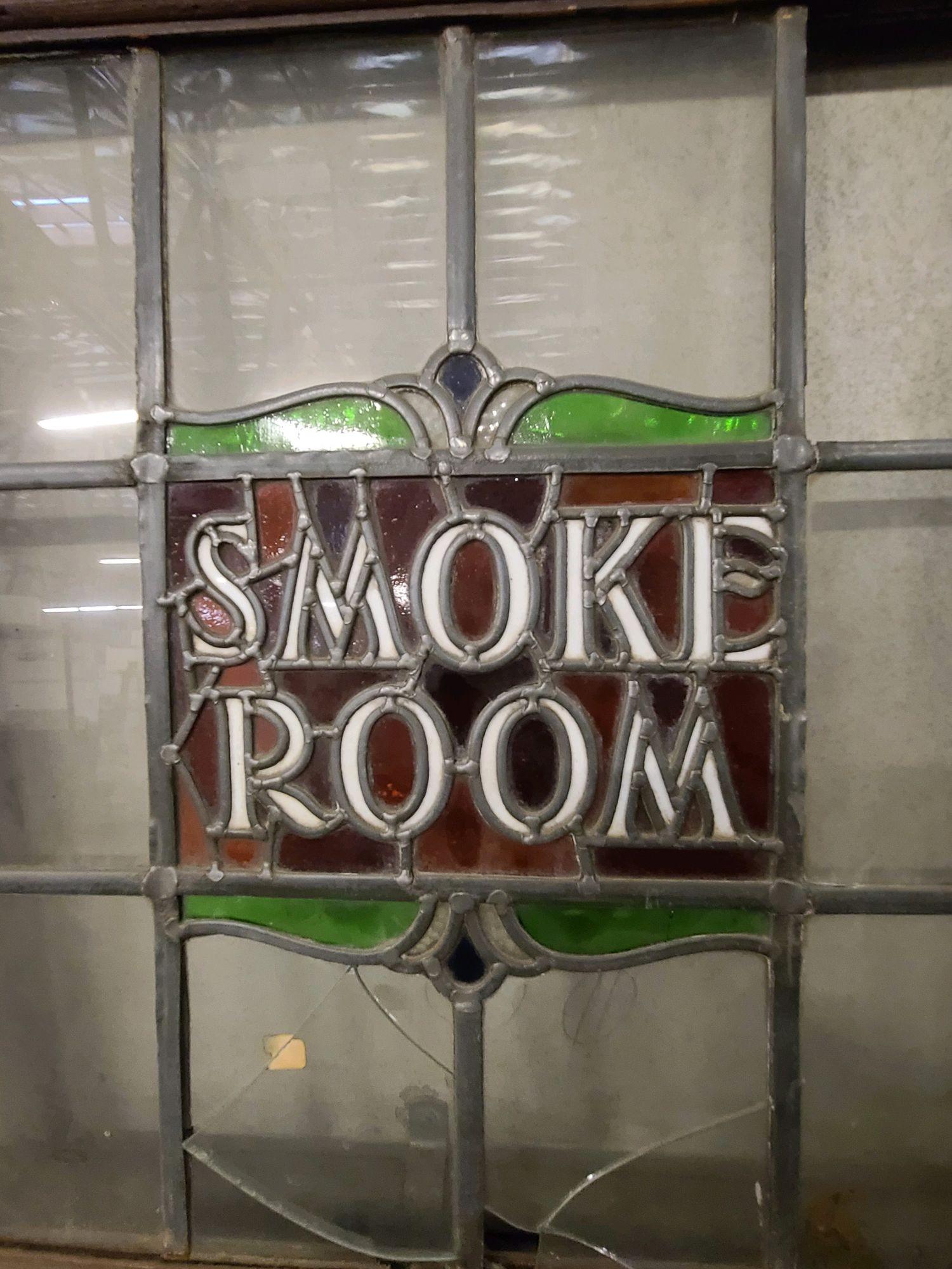 Turn of the 20th Century Mission style oak Smoking Room swinging door featuring a Stained Glass window with 