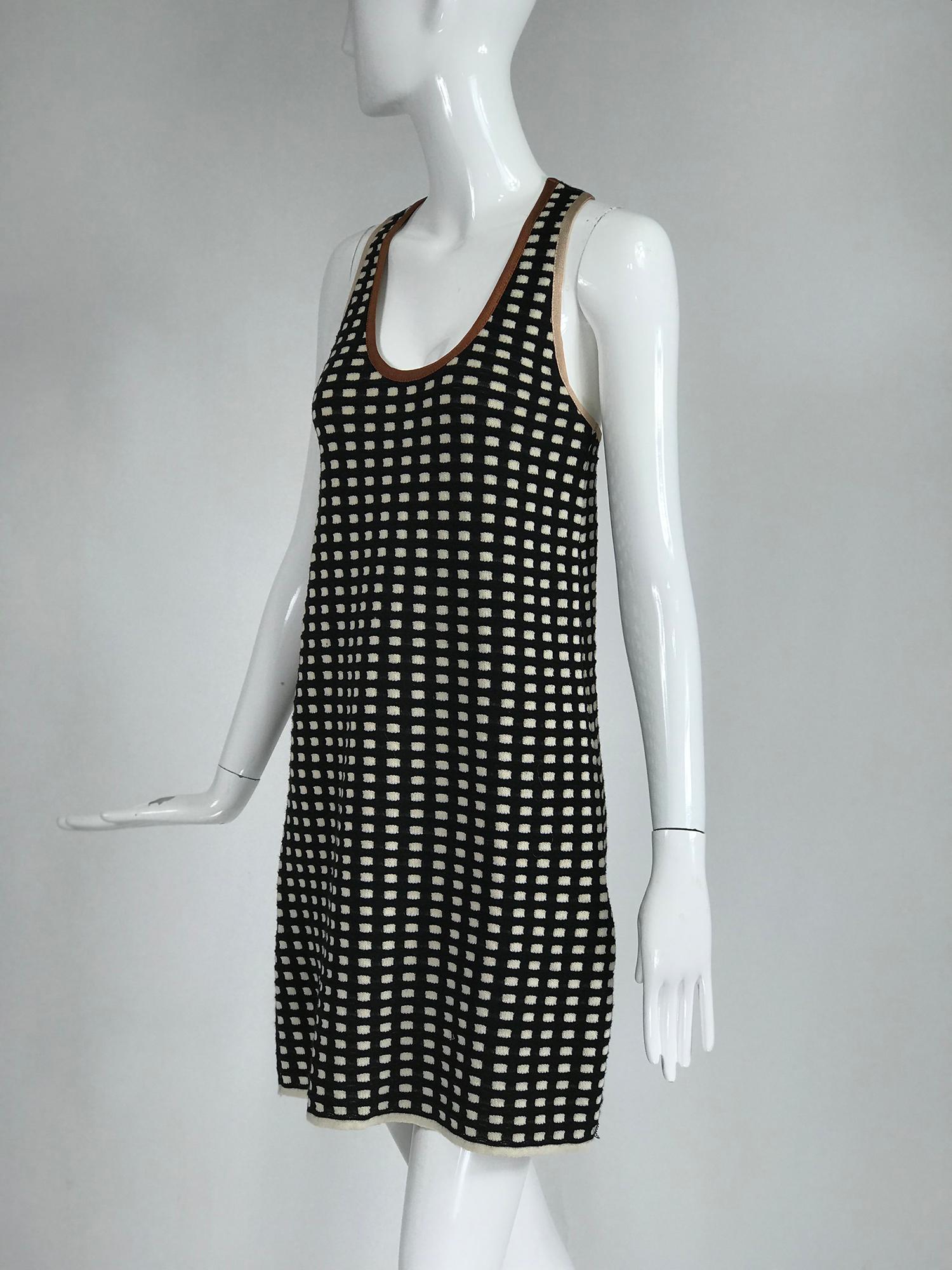 Missoni black and cream check racer back knit dress with tan and brown silky knit facings. Sporty dress perfect for layering, with nice weight. Unlined. Marked size US 2.
In excellent wearable condition.  All our clothing is dry cleaned and