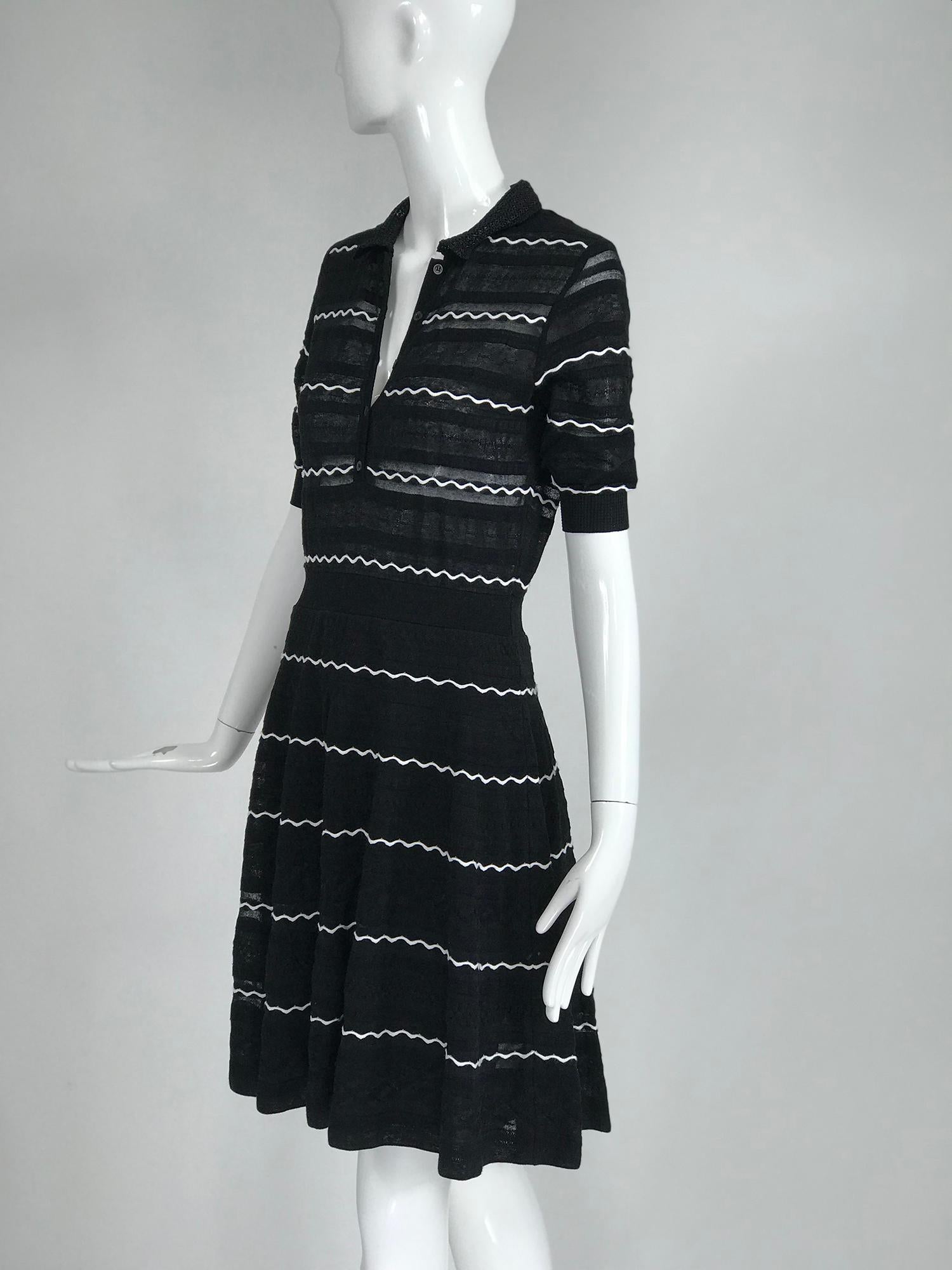 Missoni black and white fit and flare polo dress. Pull on dress with short ribbed cuff sleeves, the dress has a collar and button placket front, the waist has a knit band and the skirt flares to the hem. Black knit with a wavy knit white line, The