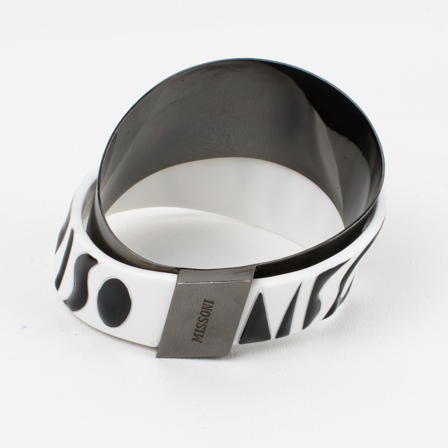 Missoni Italy created this amazing couture bracelet bangle for its ready-to-wear spring 2014 runway show. The bracelet features an asymmetric shape built with a gunmetal band mixed with a black and white Lucite (or PVC) band carved with Missoni's