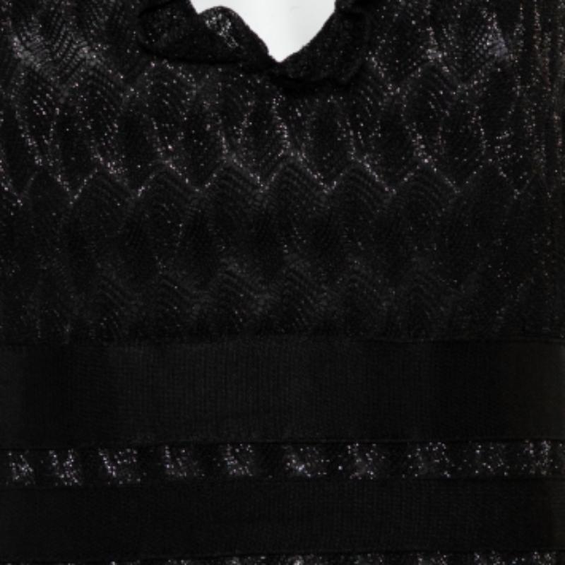 This black sleeveless dress by Missoni displays a combination of sophistication and charm. This lurex knit attire features a ruffled V-neck to highlight your collarbones. The maxi dress has a glittery effect and an elegant silhouette.