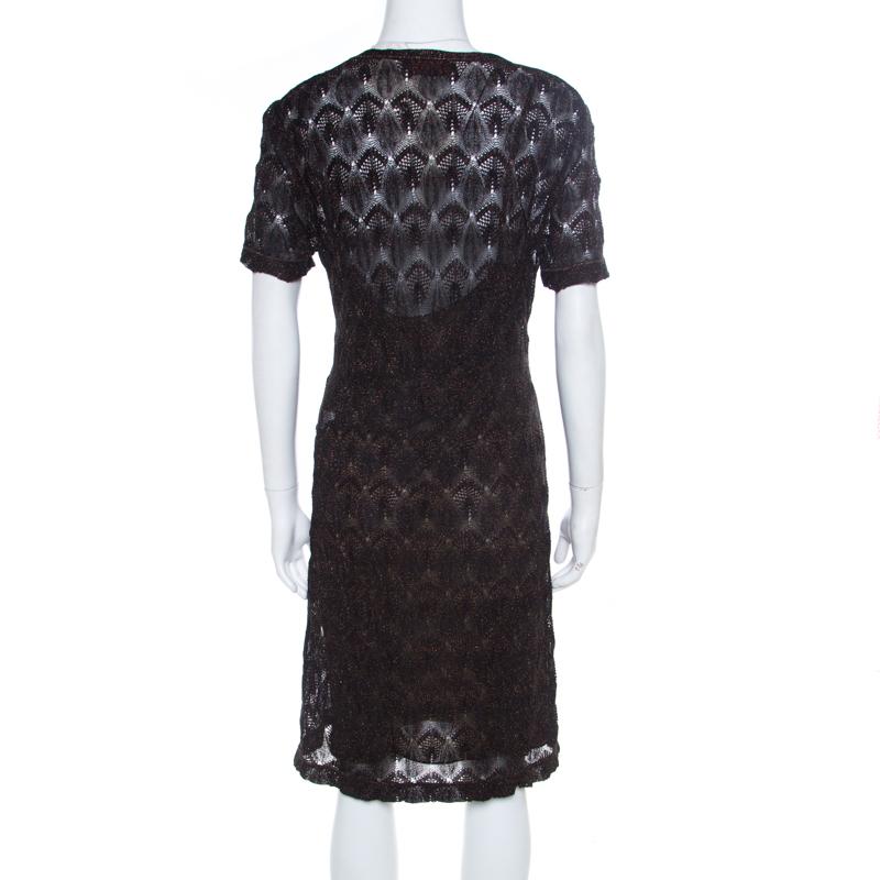 Look your fashionable best in this amazing midi dress from Missoni! The black creation is made of a rayon blend and features a lurex patterned knit design. It flaunts a V-neckline and short sleeves. Pair it with metallic stilettoes and an