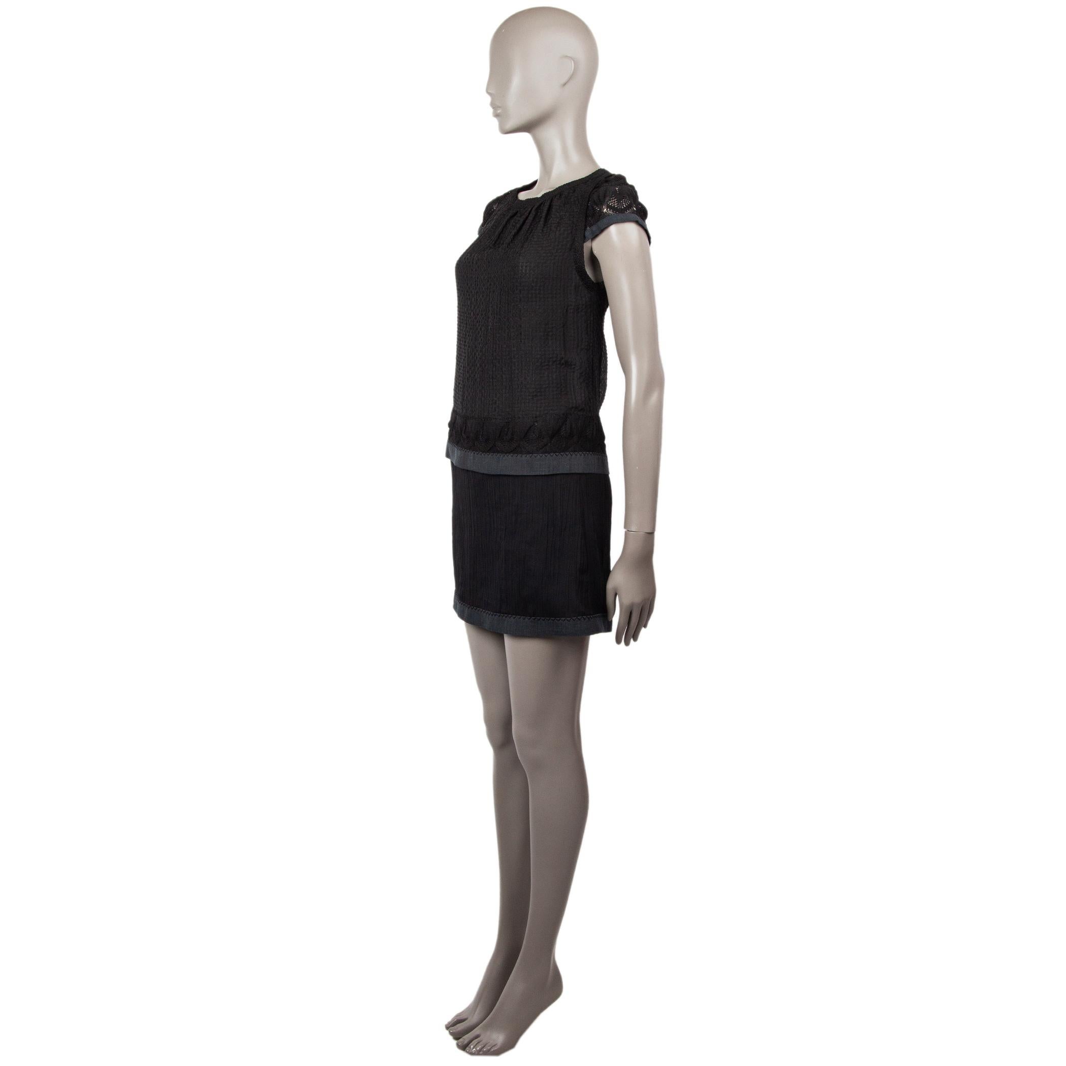 100% authentic Missoni short-sleeve crochet mini dress in black and charcoal silk (60%) and rayon (40%). With embossed tank-top layer and crepe skirt. Closes with flat buttons in colored bamboo on the back. Has been worn and one button is missing,