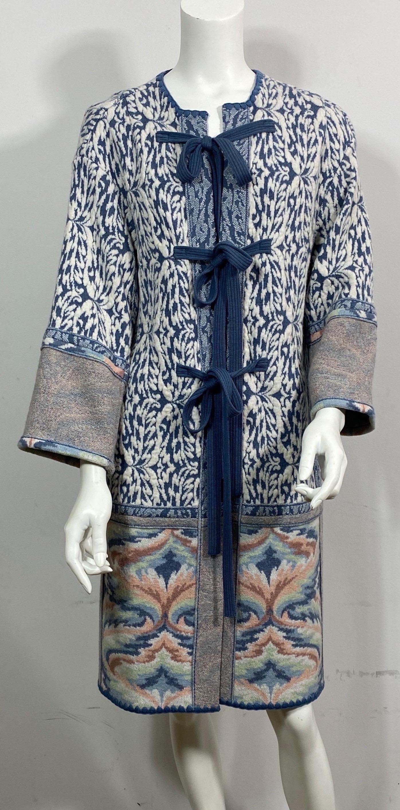Missoni Blue and Cream Wool Knit Sweater Coat - Size Small although it could fit a medium for sure. This Missoni Coat has a blue and ivory multiple patterned wool knit fabric with a round collar, 3 knit 1” tie closures along the front of the coat,
