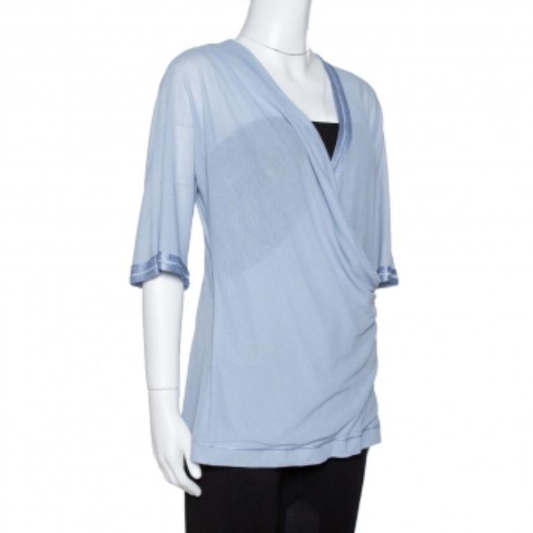 You'll love this comfortable top from Missoni for its lovely appearance and simple design. In a soothing light blue hue, this well-made top features a crossover draped front and three-quarter sleeves.