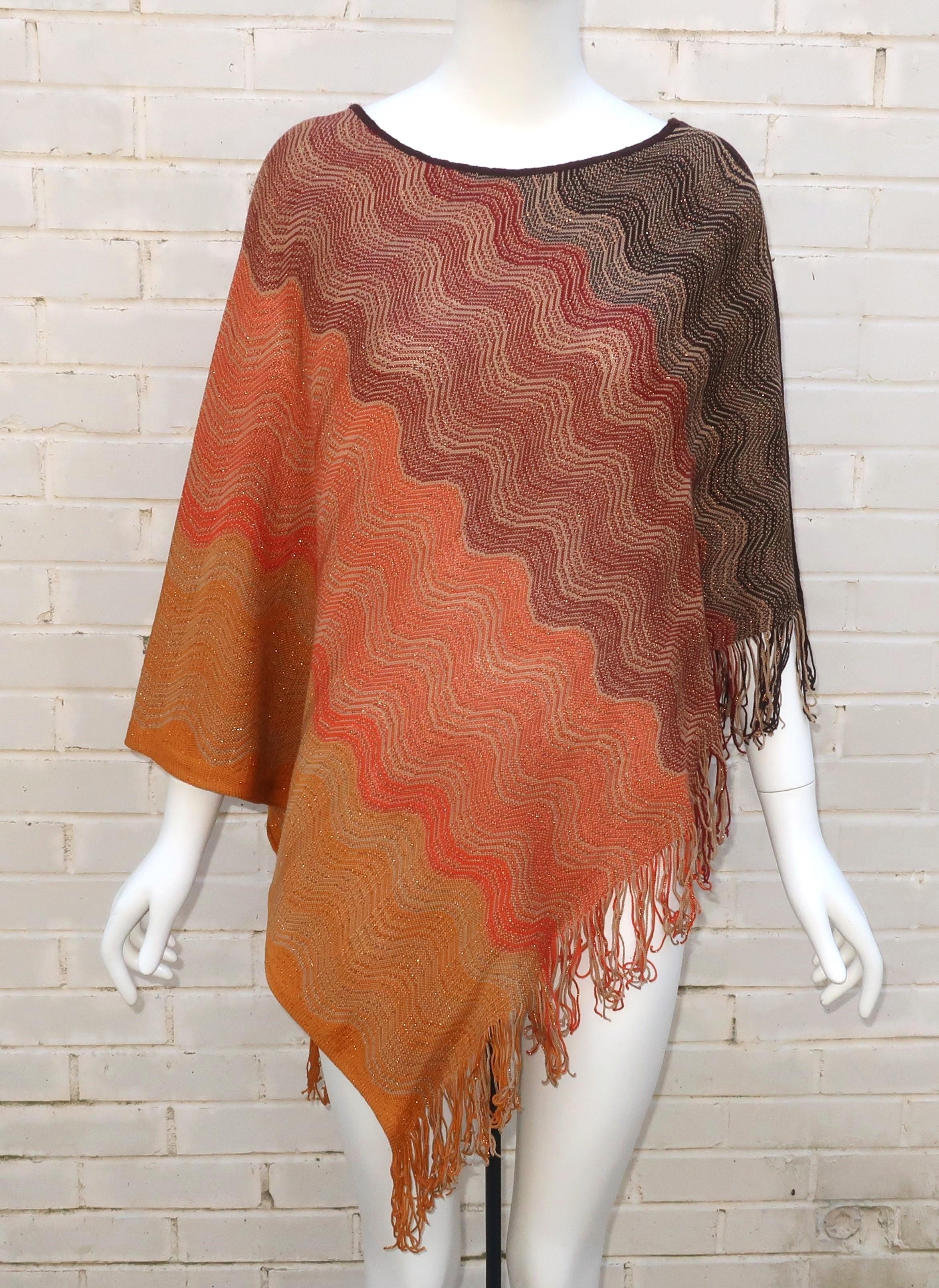 Missoni incorporates their iconic zigzag stripe pattern into a wonderful fringed wool poncho in earth tone browns with autumnal amber shades and flecks of metallic copper threading.  The casual pullover style is lightweight and can beautifully drape