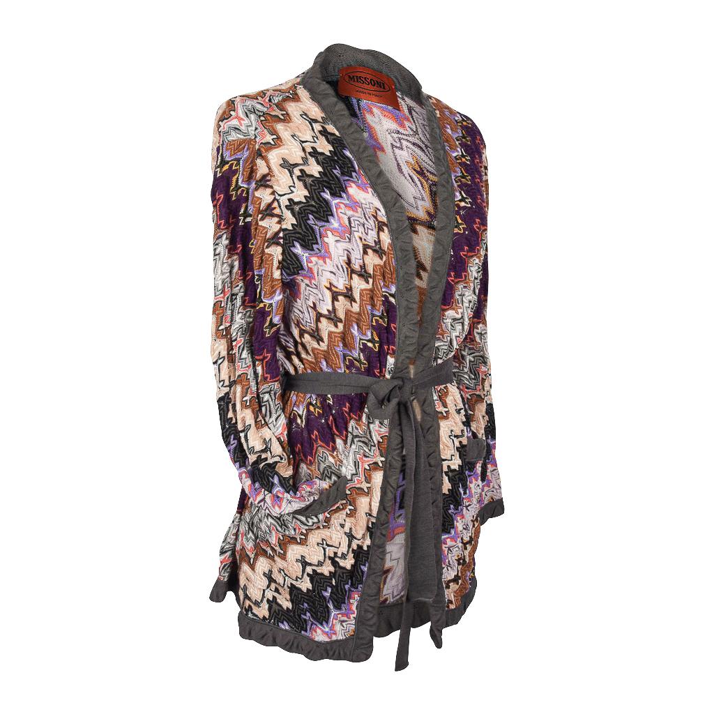 Missoni feather light cardigan features a classic knit in rich earth tones.  
Purples, nude to golds, gray, hints of black and coral. 
Trimmed in gray. 
2 front pockets
Self belt.
Fabric is viscose, polyamide and wool. 
final sale 

SIZE M

CARDIGAN