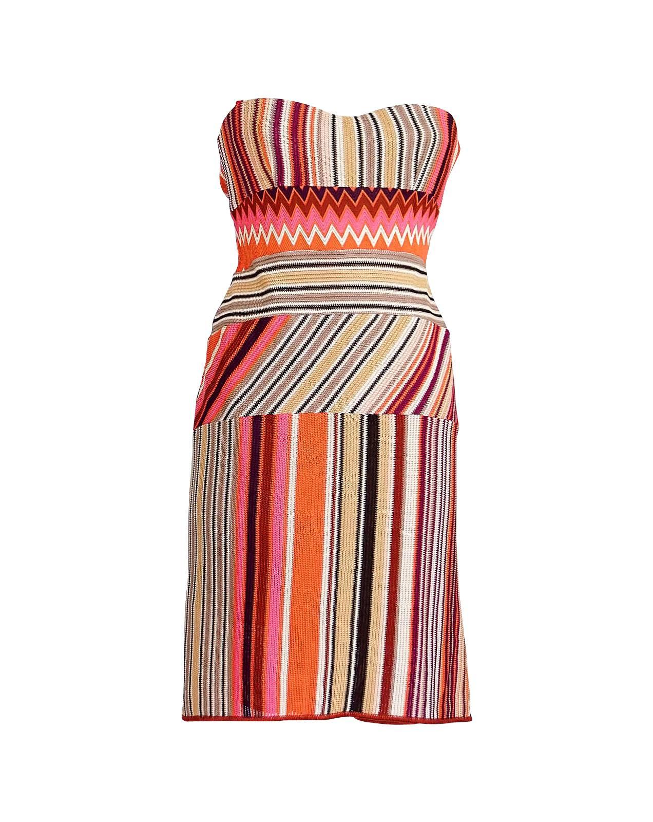 Mightychic offers a  Missoni strapless with stunning knit details dress.
Shades of pink, orange, brown, rust, gold and cranberry create a flattering shape.
Dress has 5 panels highlighting the Missoni patterns.
Interior has built in bra and boning