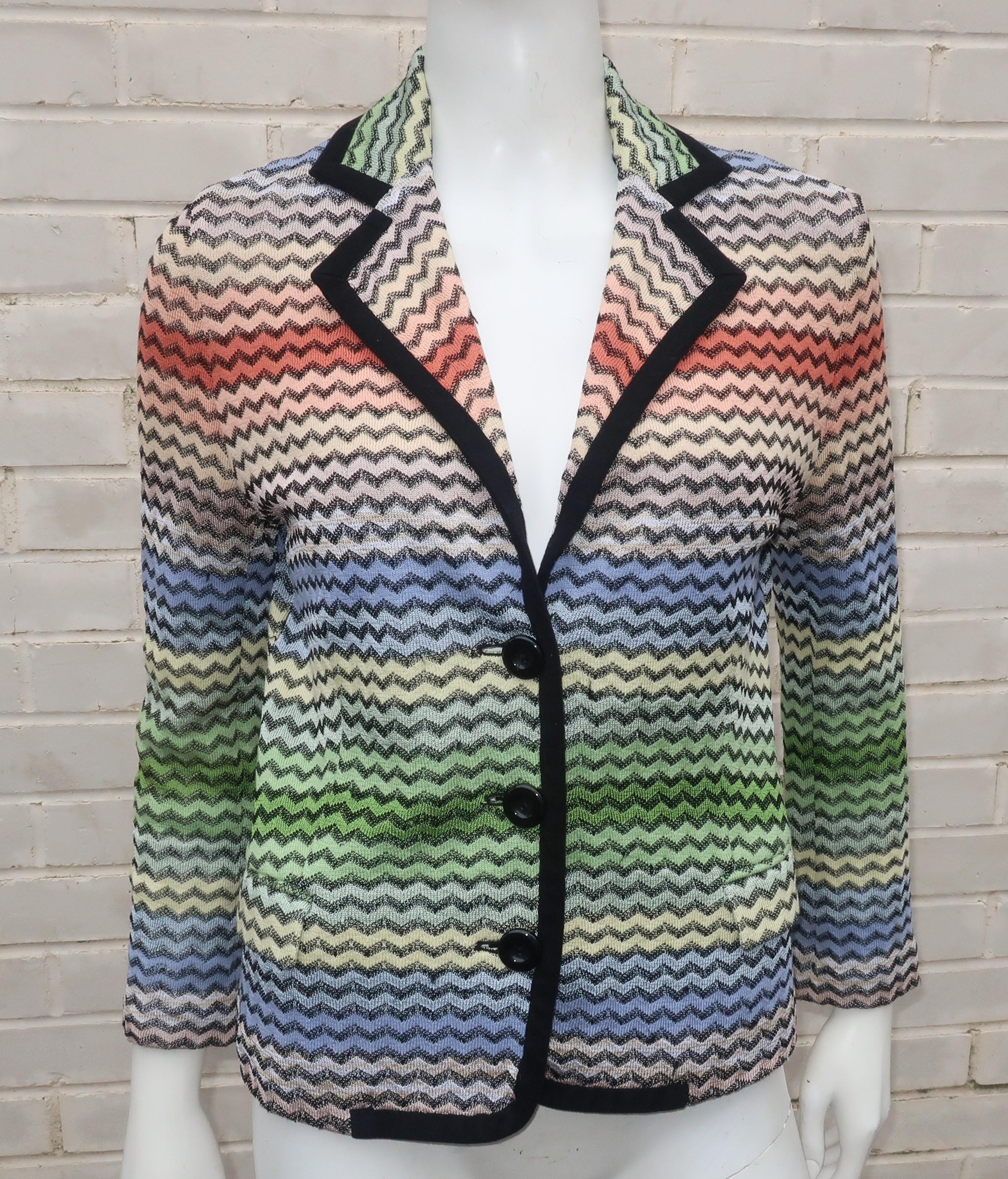Missoni creates an effortless casual knit jacket with the fashion brands iconic flame stitch design in earth tone shades ranging from terra cotta to blues and greens all outlined in black.  The collared jacket offers an easy fit with a rayon/cotton