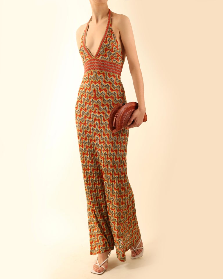 A skin tight stretch knit maxi dress by Missoni
Halter neck style dress with a low plunging neckline and backless cut
Orange, blue, brown and yellow print

Composition:
65% Rayon, 35% Silk

Size:
IT 42 but will work for various sizes (Please refer