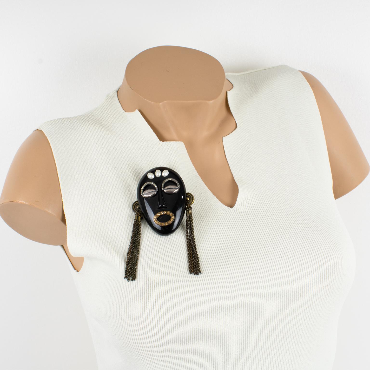 This is a rare iconic Missoni Italy brooch designed for their 1991 jewelry collection. The pin features a dimensional oversized carved tribal mask in black resin, ornate with silver plate coffee bean eyes and tiny crystal rhinestone eyebrows. The