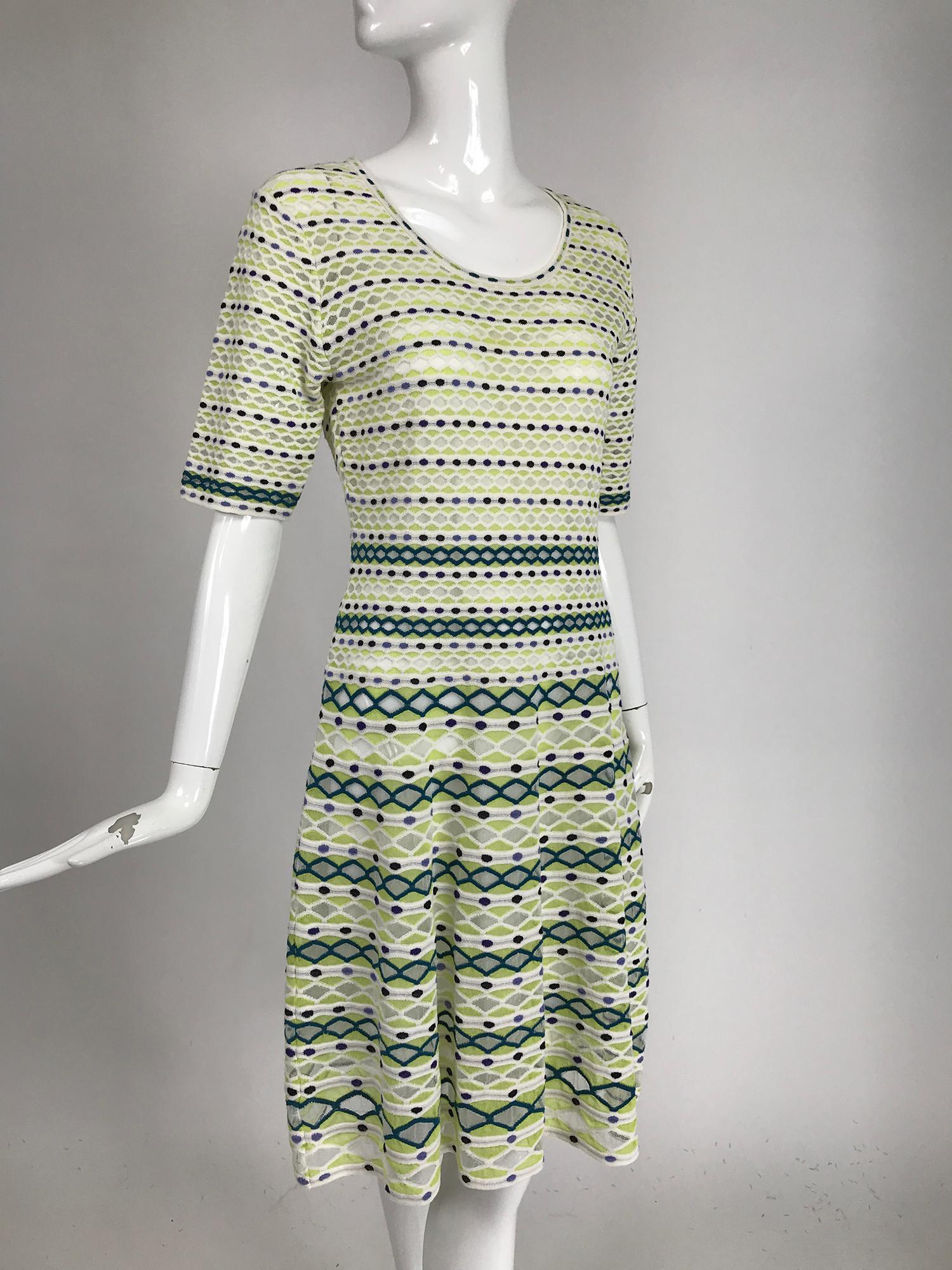 Missoni lime, white & black honeycomb knit dress. Pull on dress with scoop neck, elbow length sleeves and a fit and flare shape. The stretch knit sheer in a pattern surrounded with white knit outline, inter spaced with bands of black and blue oval