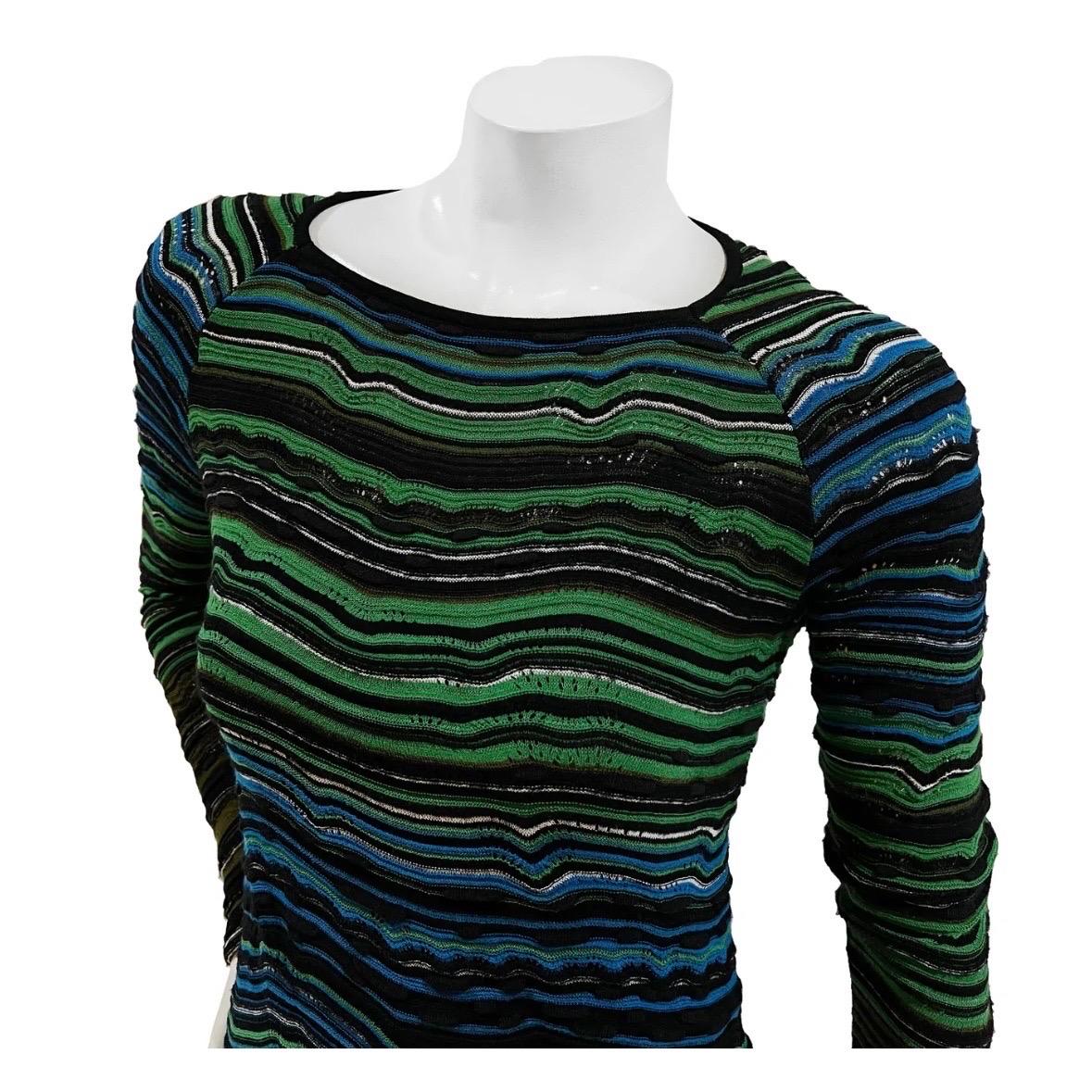Long Sleeve Wave Knit Dress by Missoni 
Circa late 90s
Green/Blue/Black
Knit wave stripe detail throughout dress
Long sleeve
Fabric stretches
Dress has black spaghetti strap slip
Made in Romania 
Fabric Composition; 65% Viscose, 14% Synthetic, 10%