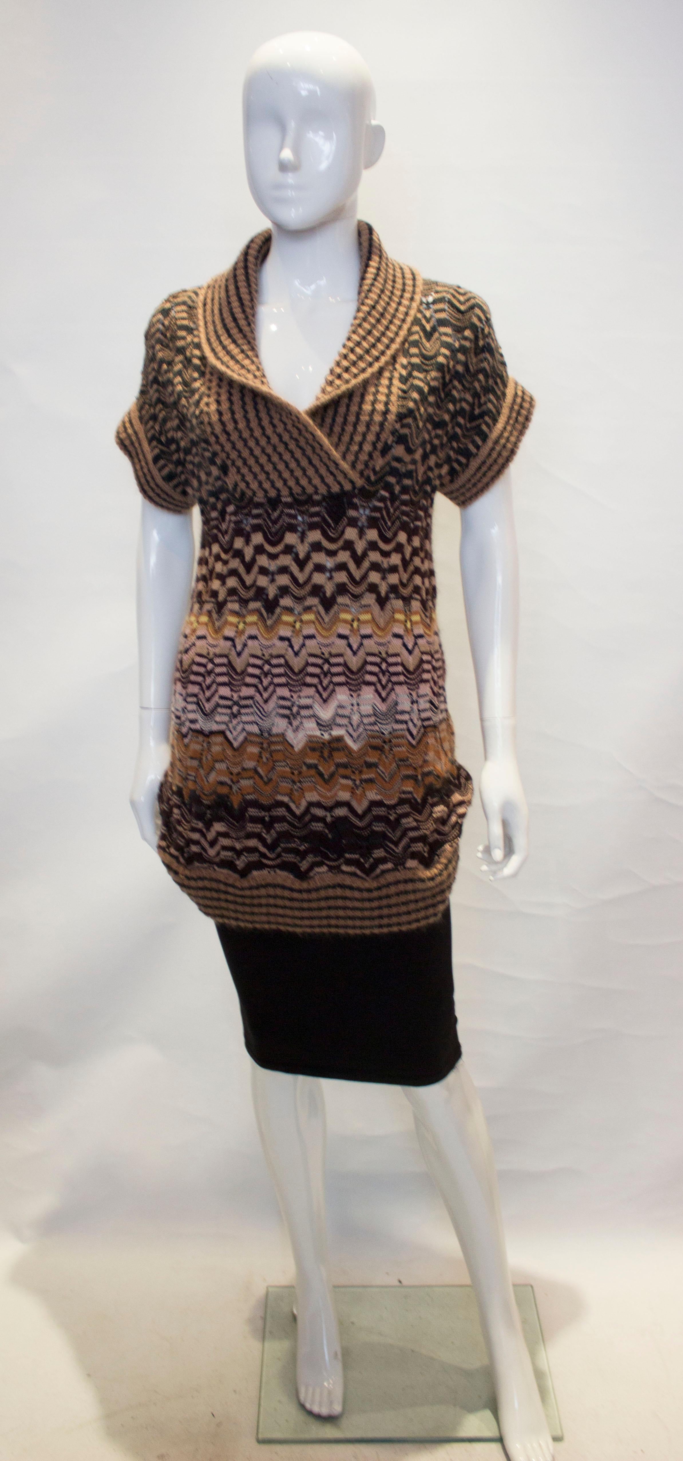 A chic and easy to wear jumper by Missoni, Brown label. The jumper has cap sleaves, with a wide attractive v neck collar, with the same detail on the arm holes.