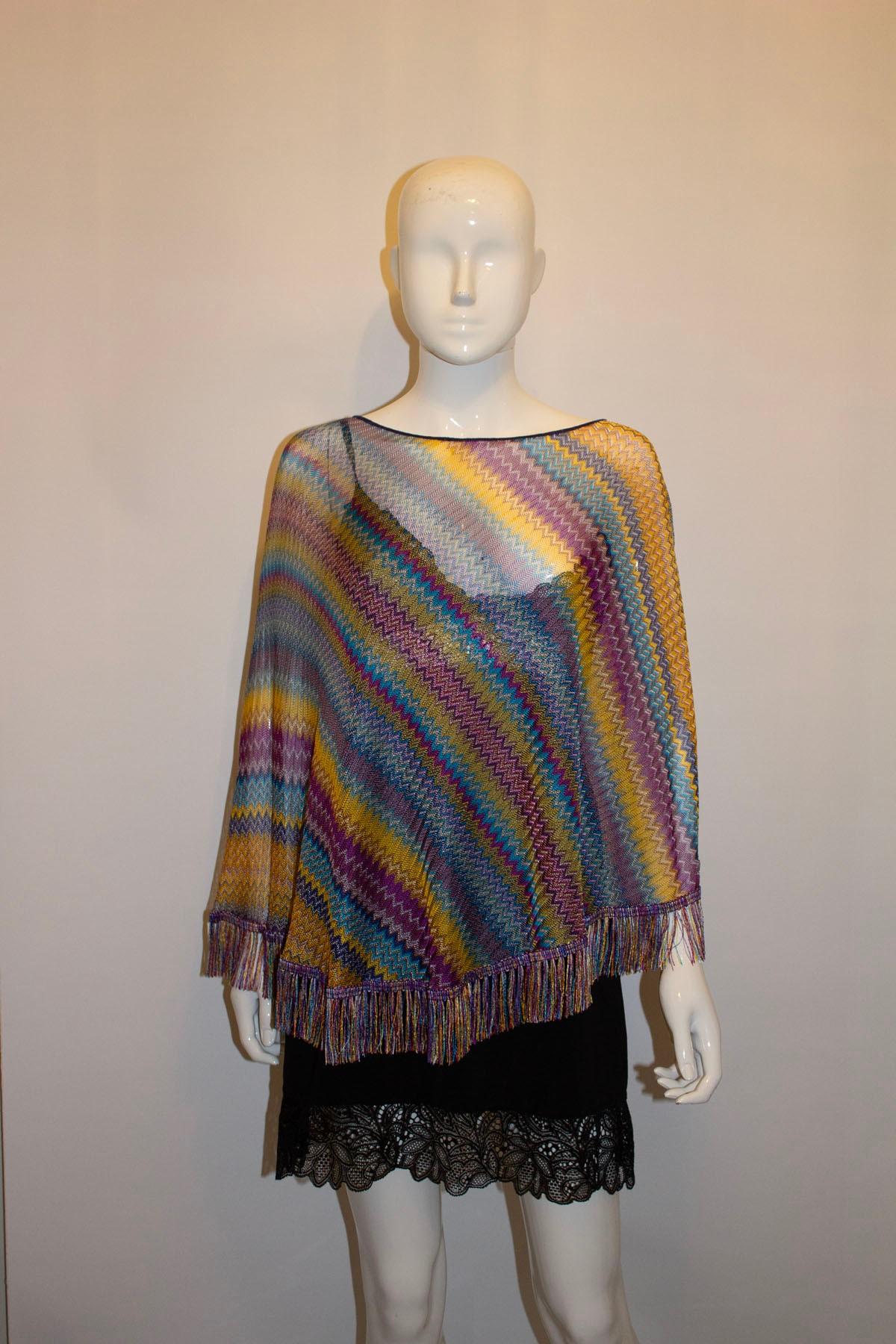A pretty multicolour poncho by Missoni main line - brown label. In a wonderful knit , the poncho has a length of 30'' . 100 % viscose . Unworn