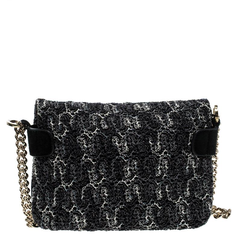 A lovely accessory to complement both your casual and party looks, this Missoni bag is crafted with suede and detailed with metallic crochet work. The monochrome twist lock opens to reveal a fabric interior which dutifully stows your basics. The