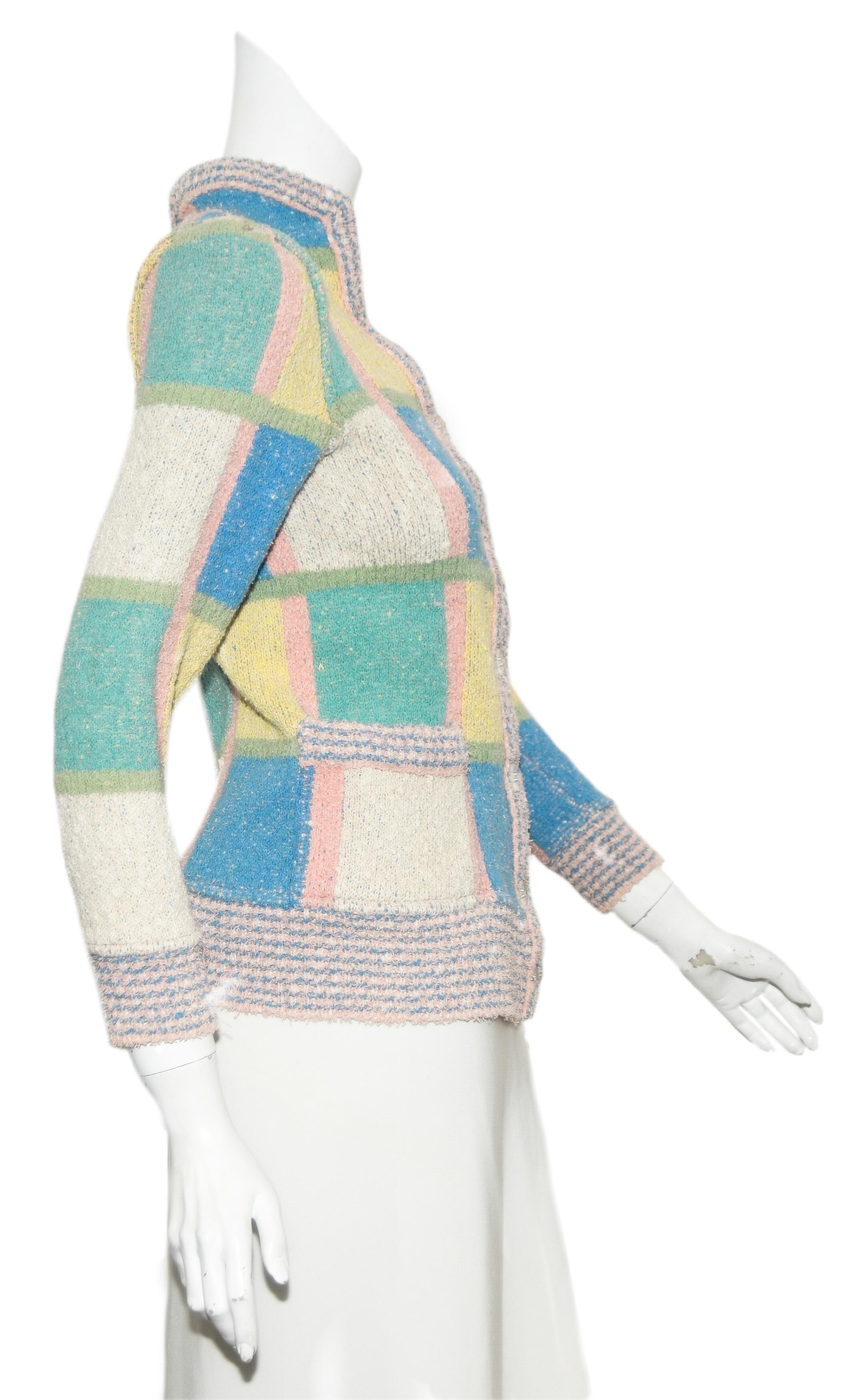 Missoni multi 1970's mod pastel color sweater jacket includes large check pattern throughout.  This jacket is not lined.  For closure 7 clear buttons at front.  The long sleeves and hem are ribbed.  This jacket was inspired by the 1970s Mod shaggy