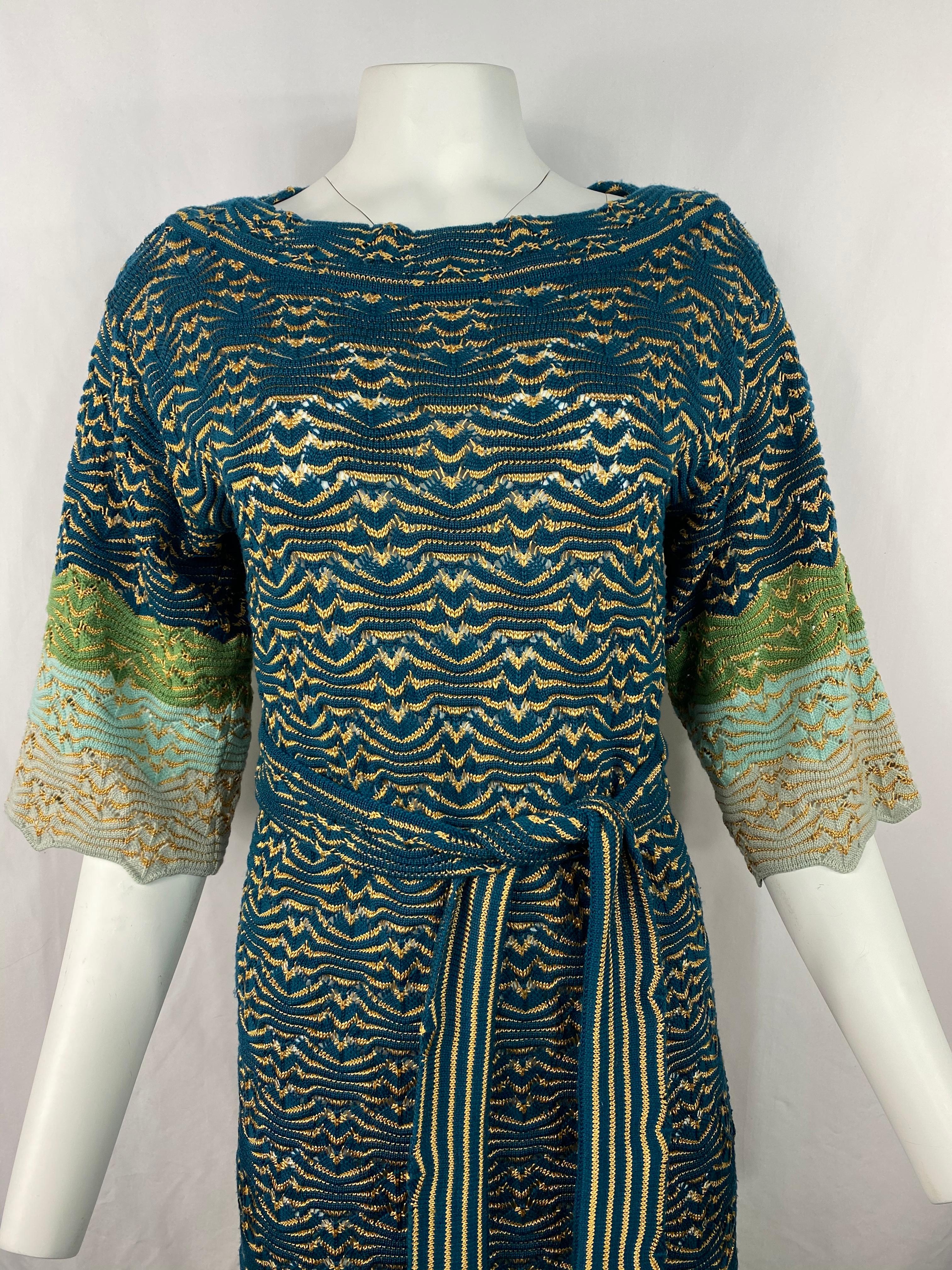 Product details:

Featuring blue, green and brown knit abstract striped detail, knee length, 3/4 flare sleeves ( measure 16