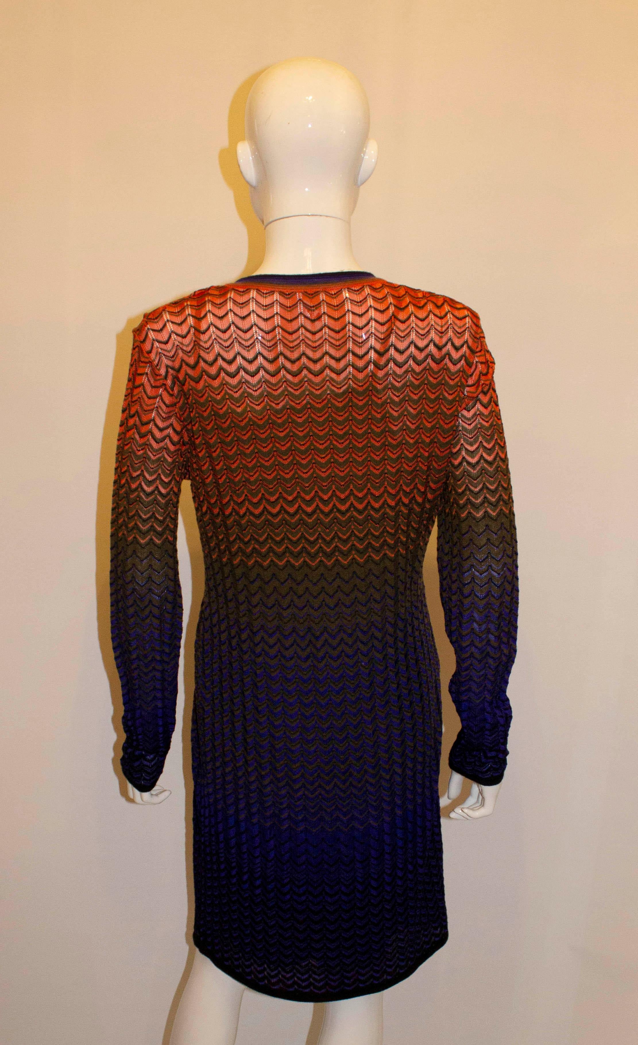 A chic and easy to wear dress by Missoni. In a mix of blue , purple, grey and orange, the dress is lined with a v neckline. Size 46  Measurements: Bust 37'', length 38''