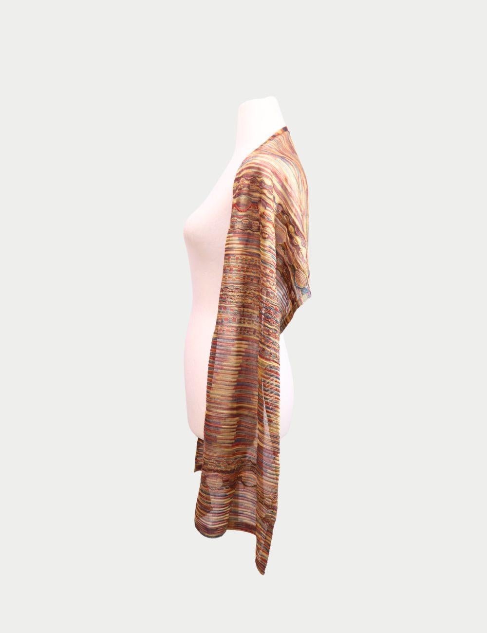 Celebrate vibrant Italian craftsmanship with this Missoni Multicolor Knit Scarf, a signature piece from the fashion house known for its bold and artistic patterns. Featuring a lively mix of warm tones in red, orange, gold, and purple, this scarf is