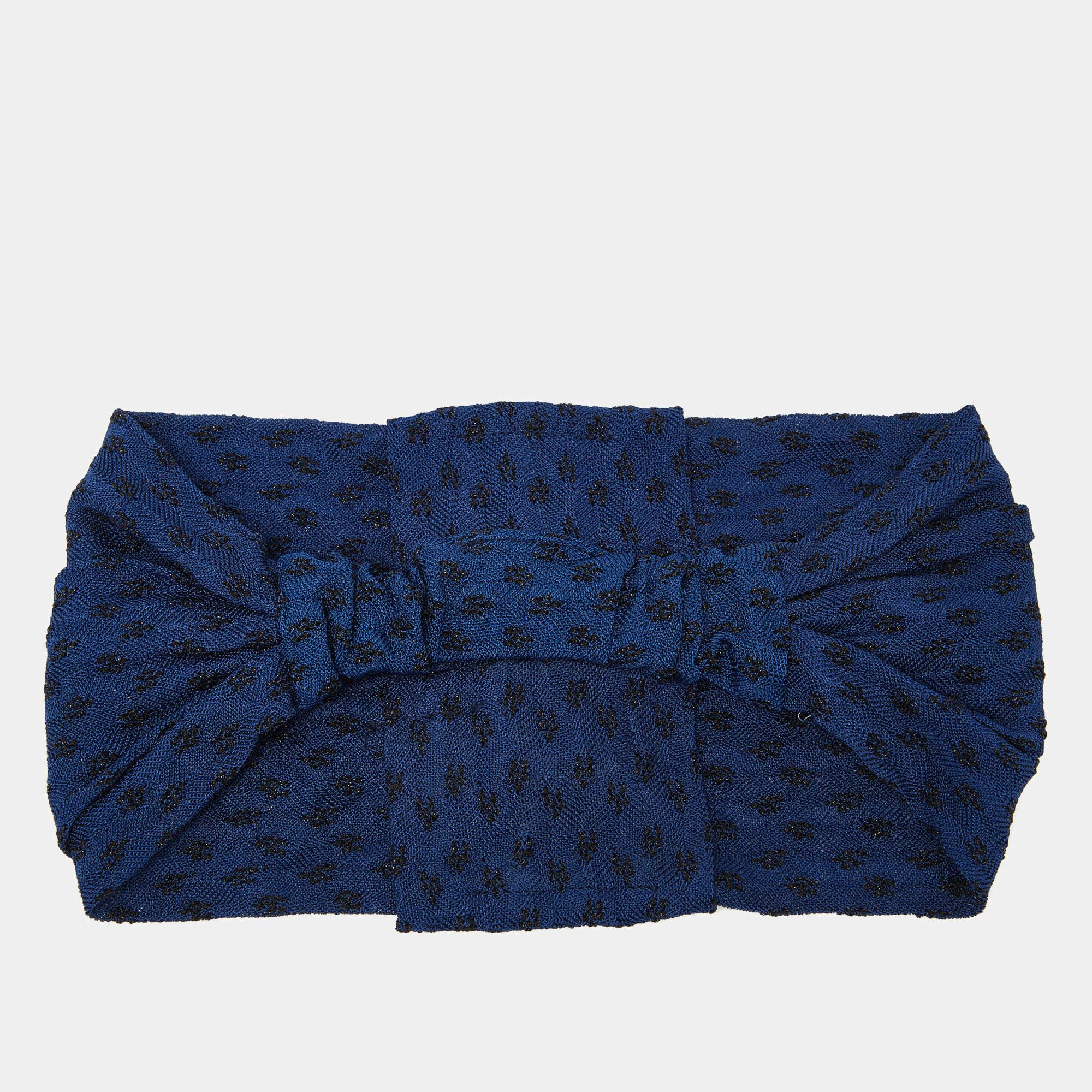The Missoni headband combines style and comfort effortlessly. Crafted from luxurious knit fabric it features the iconic Missoni pattern in rich navy tones. This versatile accessory adds a chic touch to any outfit while its soft texture ensures a