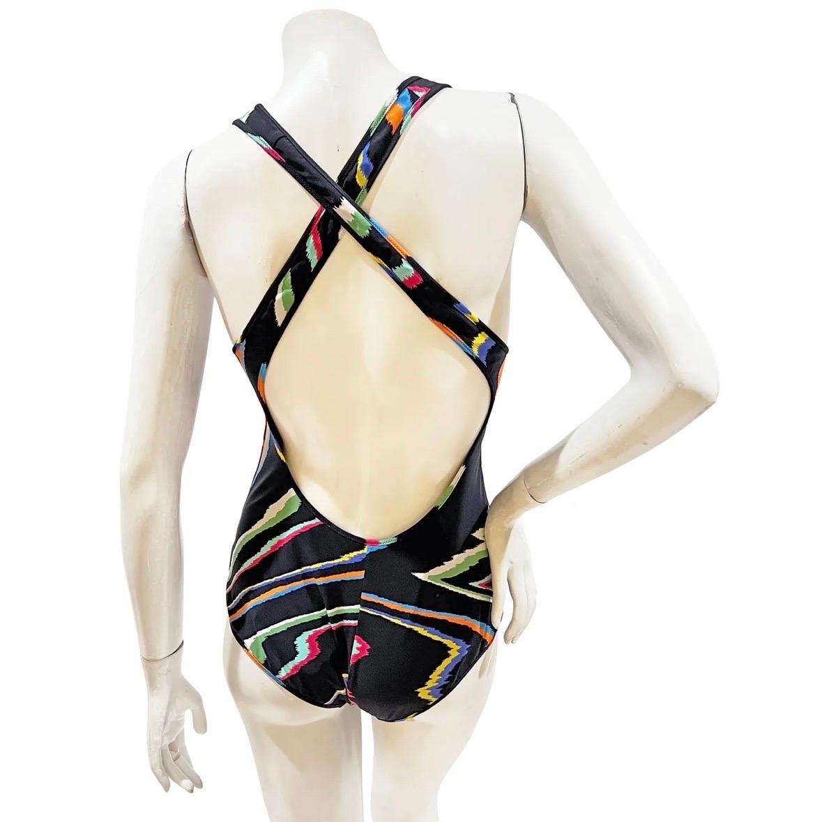 One piece vintage swimsuit by Missoni Mare
Made in Italy
Black with vertical multicolor squiggle graphic 
Criss-cross back straps  
Fabric Composition; 73% nylon, 27% elastane
Excellent condition; New with tags. 
Size/Measurements: (approximate,