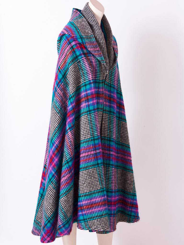 Missoni, wool knit, multi tone, midi length, cape with hood having a plaid motif on a black and white heather ground.