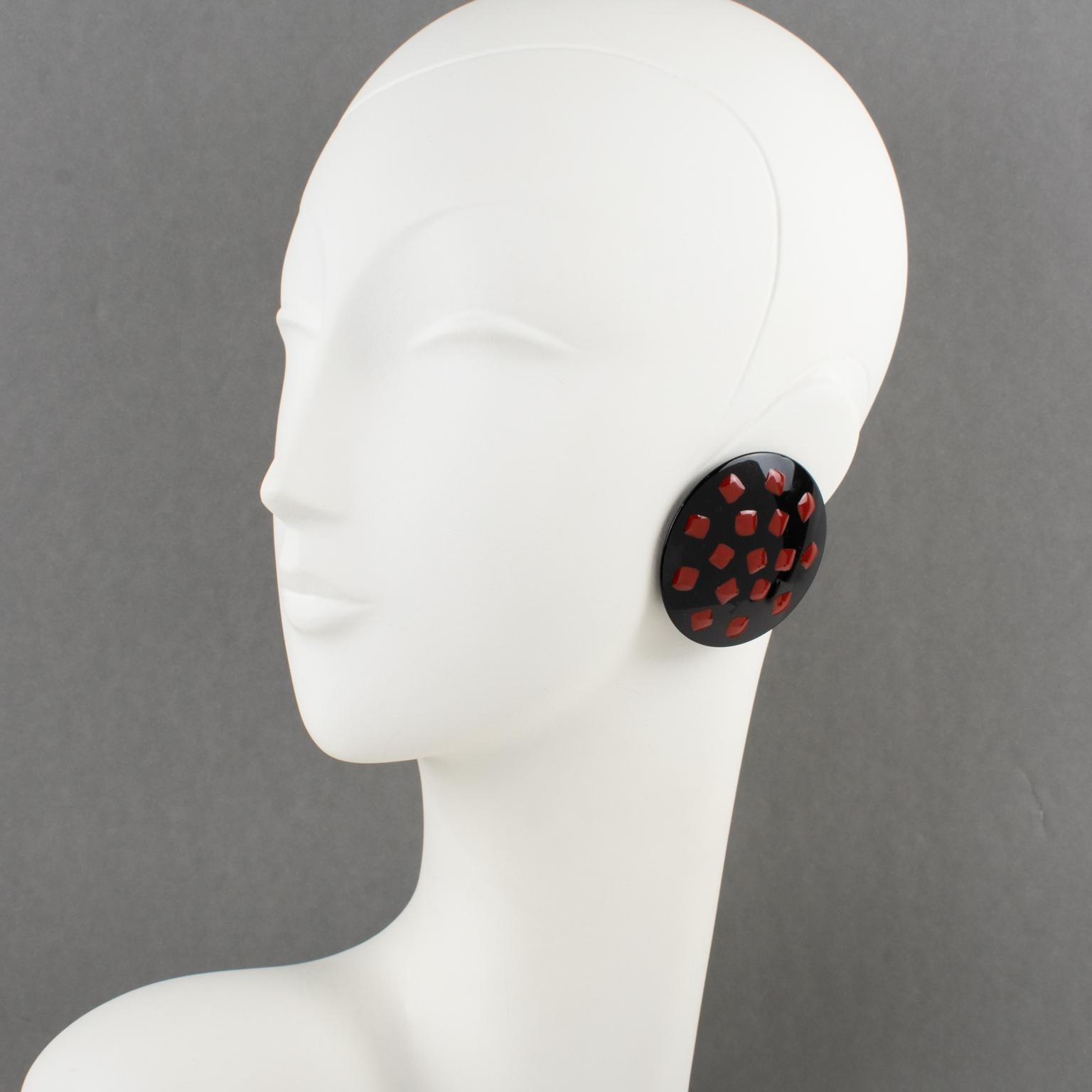 These lovely 1980s Missoni, Italy oversized Lucite or Resin clip-on earrings feature a hand-made domed dimensional rounded shape with red polka dots applied over a black background. Each earring is marked on fastenings 