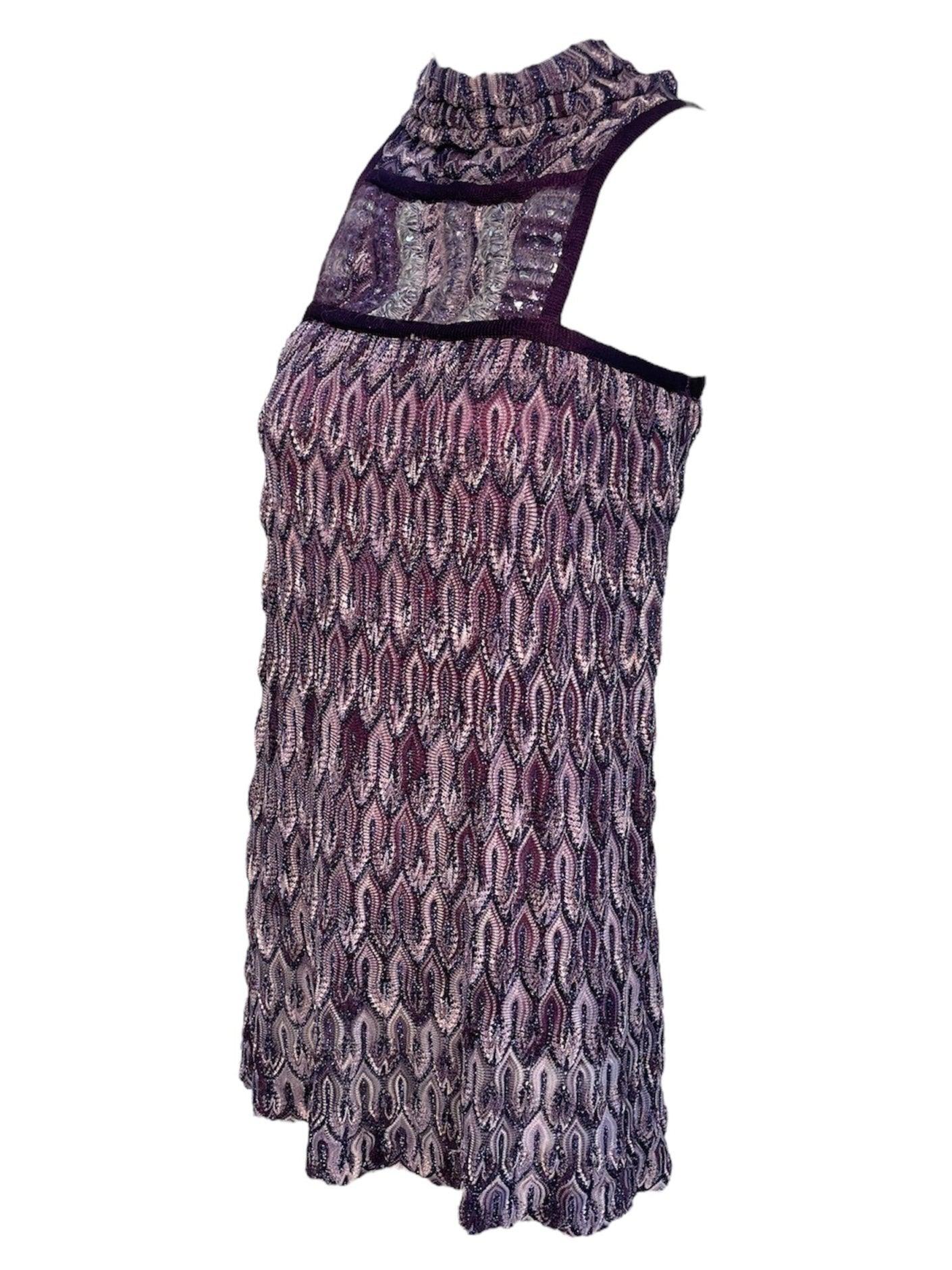 Funky little Missoni mini dress in their iconic flame stitch knit pattern. Monochromatic shades of purple with metallic lurex woven into the stretch knit. Sequin knit panel across the upper chest. Mock neck collar. Hidden side zip and hook closure.