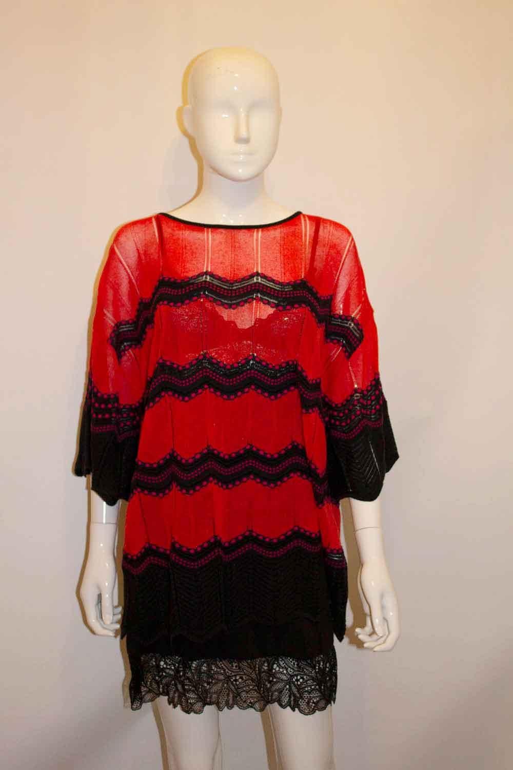 A fun and easy to wear top by Missoni. In a festive red and black, the top has a round neckline. 
Size 46, 96 A . Measurements Bust up to 48'', length 31''