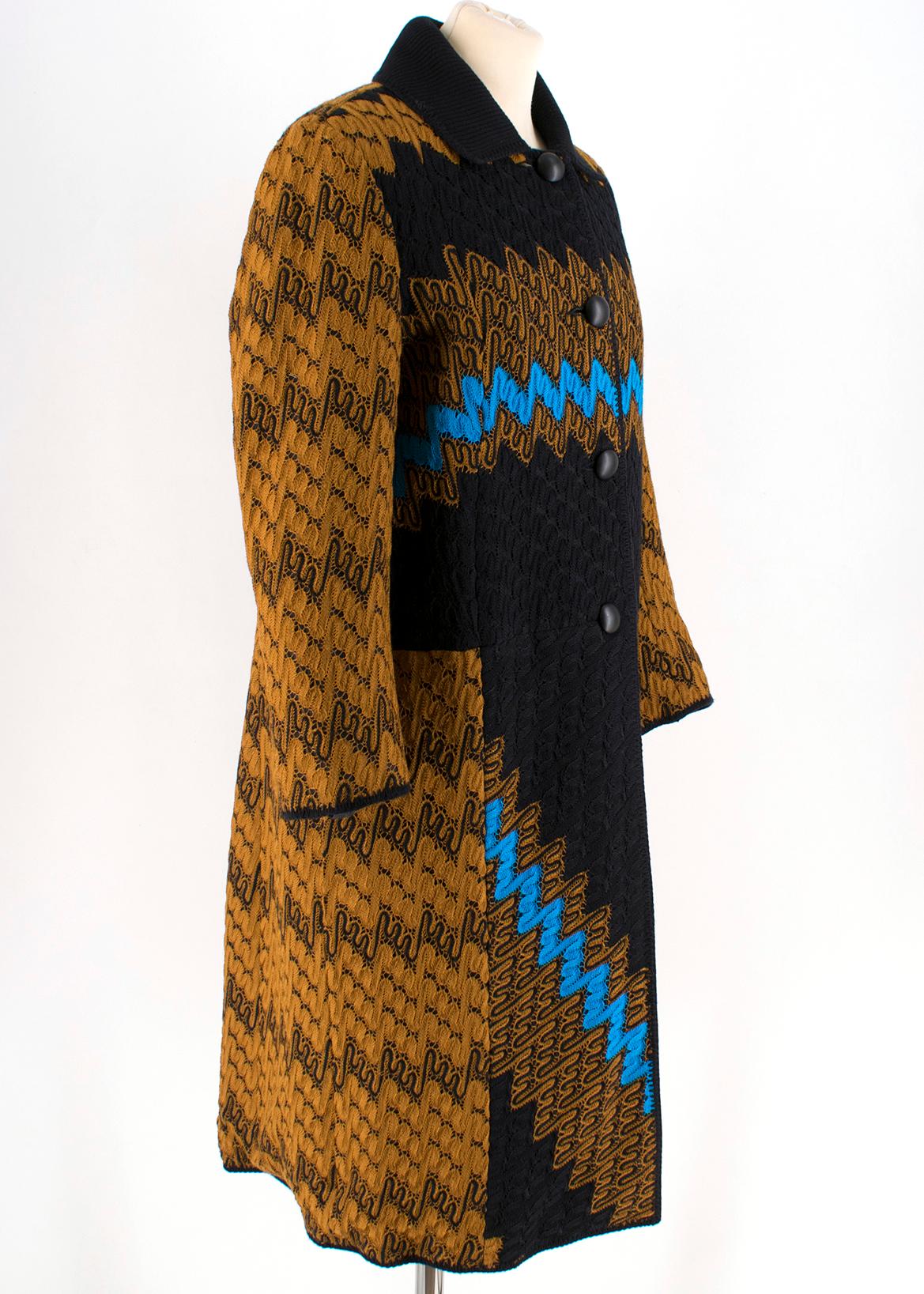 Missoni Reversible Zigzag Crochet Knit & Satin Shell Coat 

-Gold, blue, and black coloured 
-Wool knit blend 
-Black stitching trim
-Four-button front closure 
-Ribbed collar
-Two functional side pockets
-Silk-blend lining 
- Satin Shell reversible