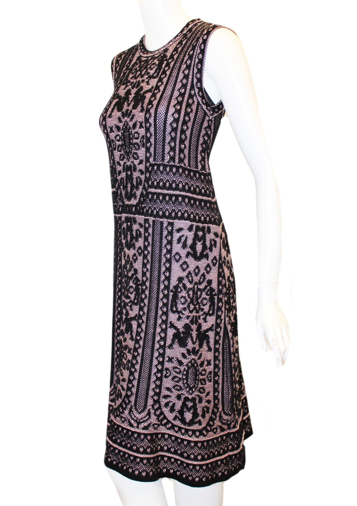 Missoni rose and black dress incorporates in its design silhouettes of women throughout the knitted print.  This dress contains a black slip.   This round collar midi length dress is unique in its design that emphasizes the female body.  This dress